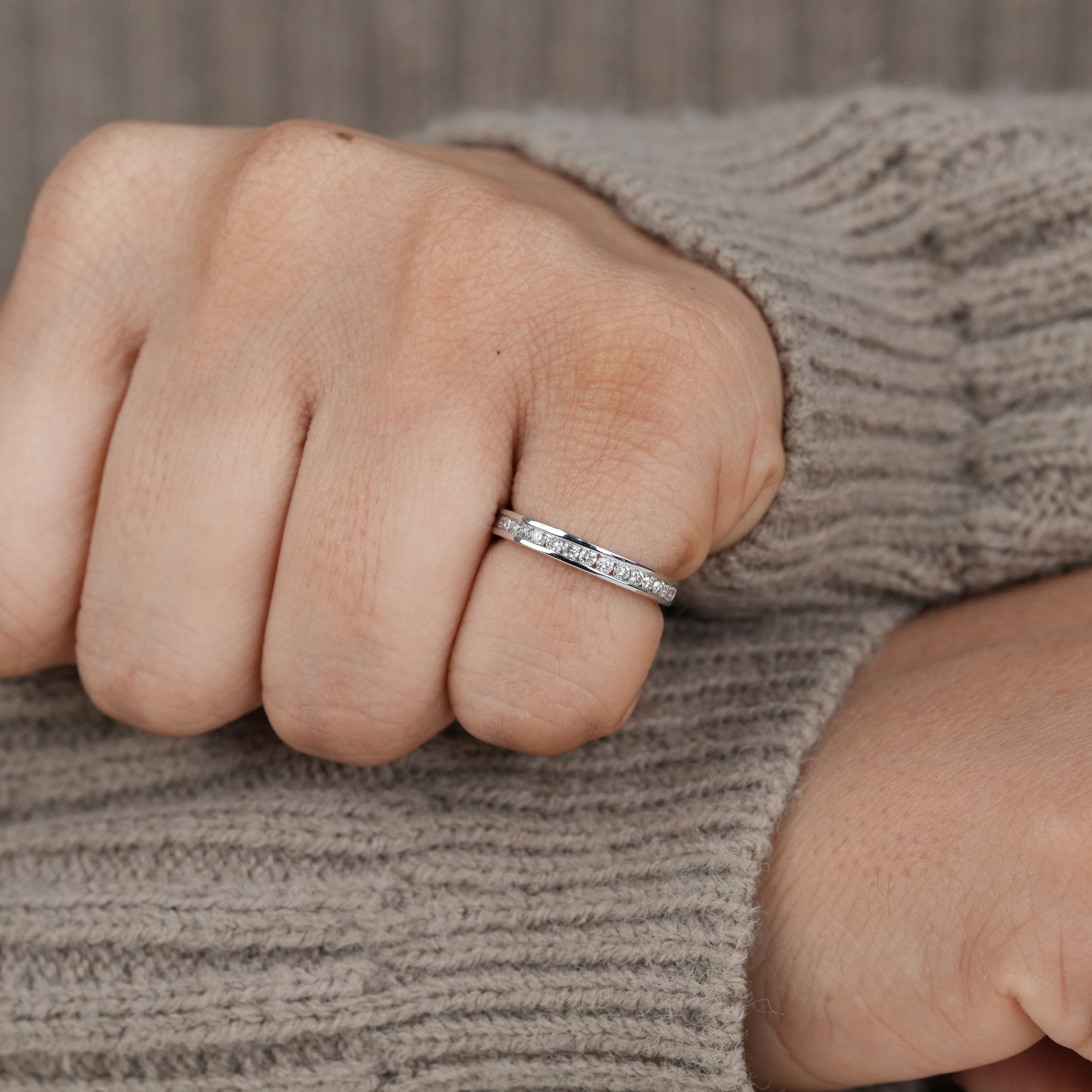 Close up channel set lab grown diamond band with polished finish