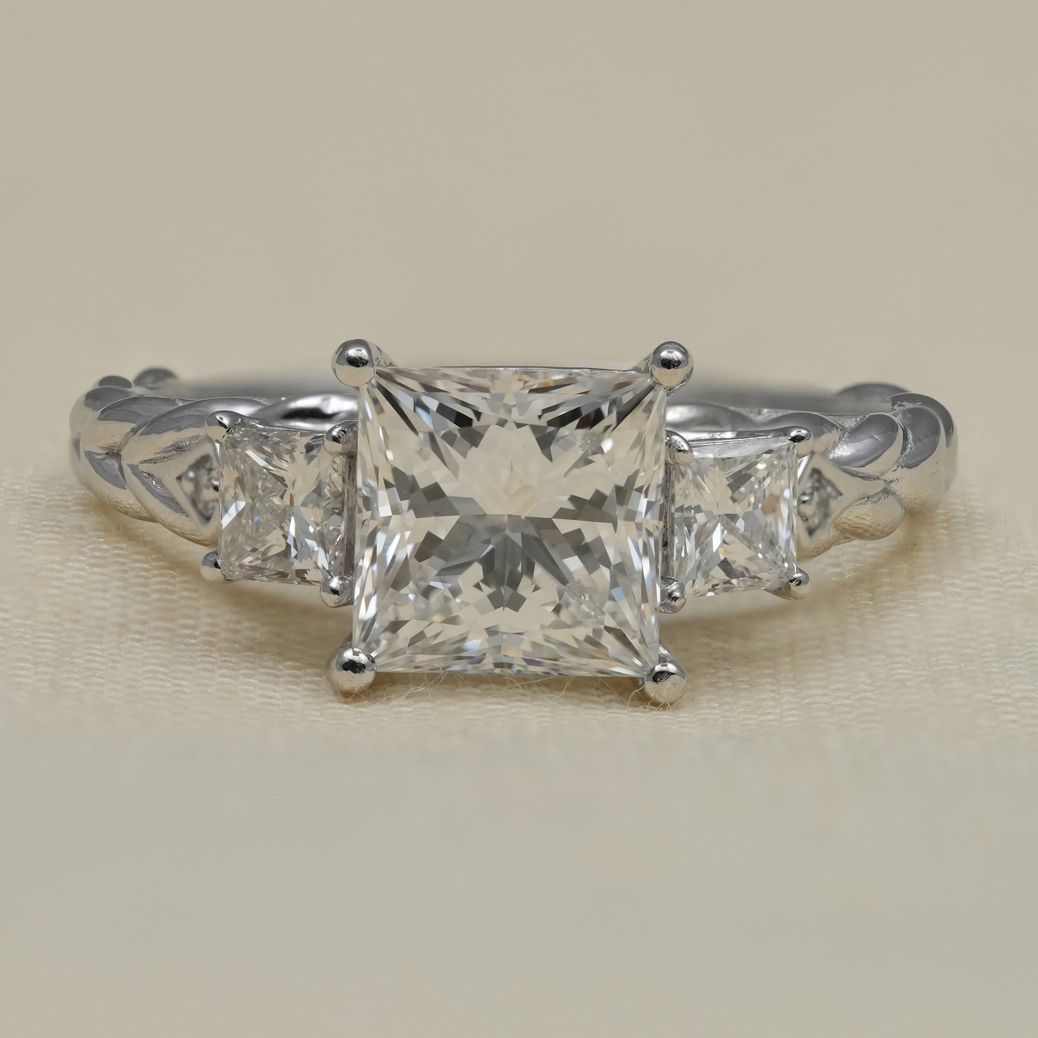 Princess cut lab grown diamond three stone engagement ring engraved band