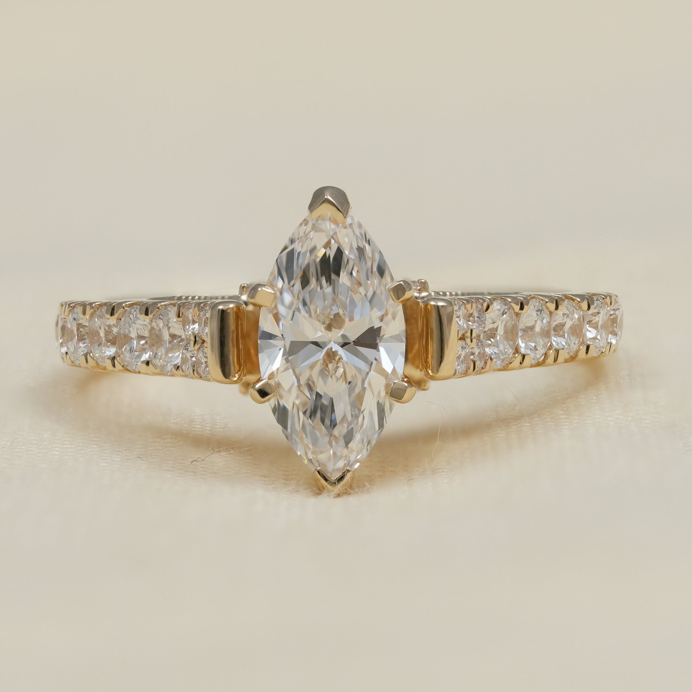 Marquise lab grown diamond engagement ring with pavé yellow gold band
