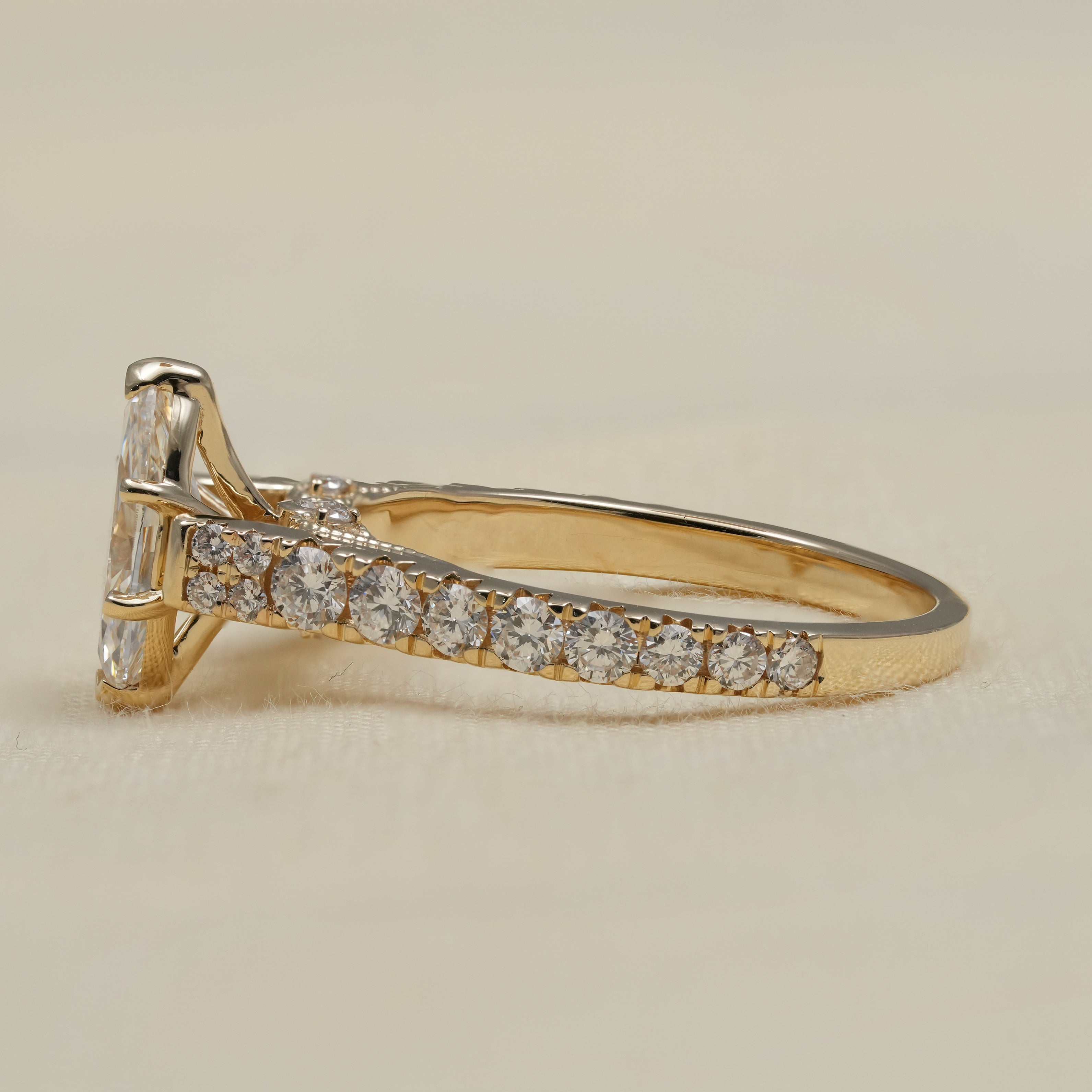 Close up marquise lab grown diamond engagement ring with pavé band