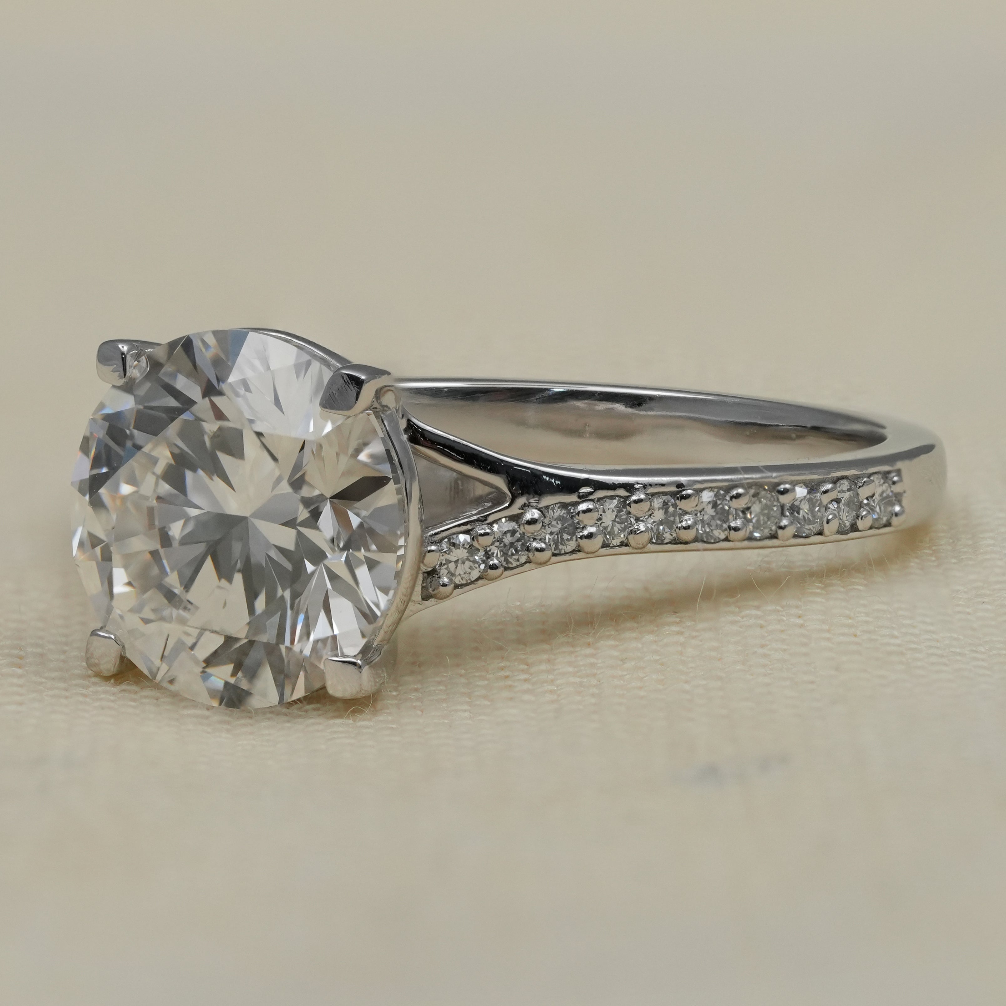 Classic round lab grown diamond solitaire ring with pavé shoulders