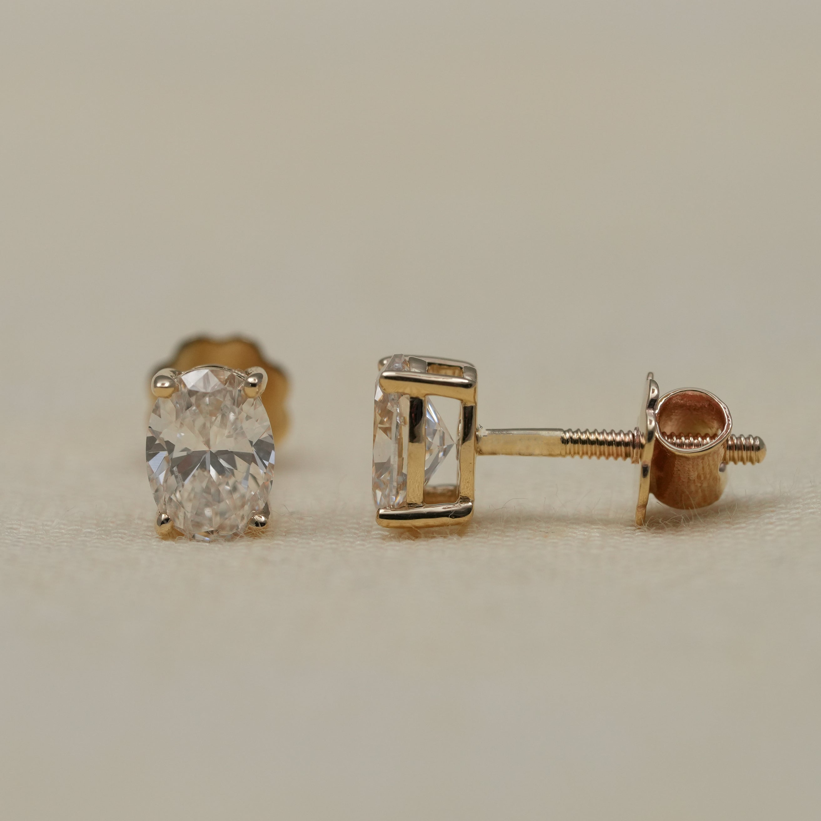 Classic oval lab grown diamond studs set in warm yellow gold