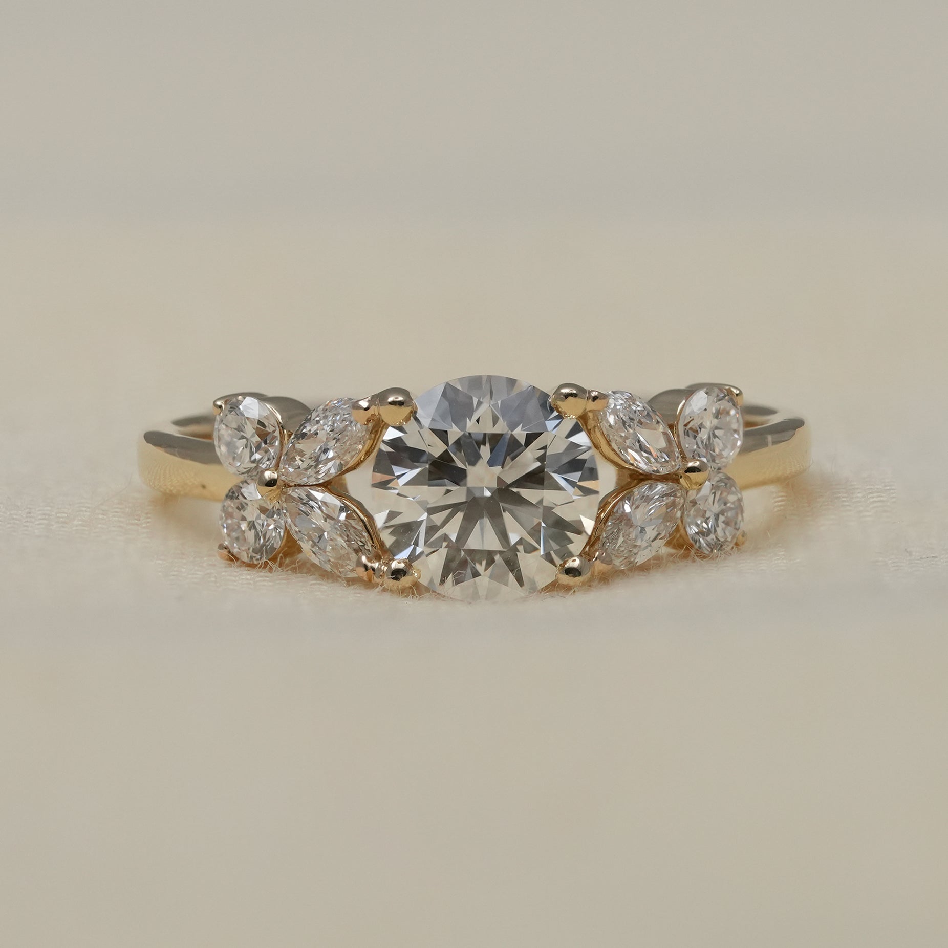 Round lab grown diamond engagement ring with marquise floral accents