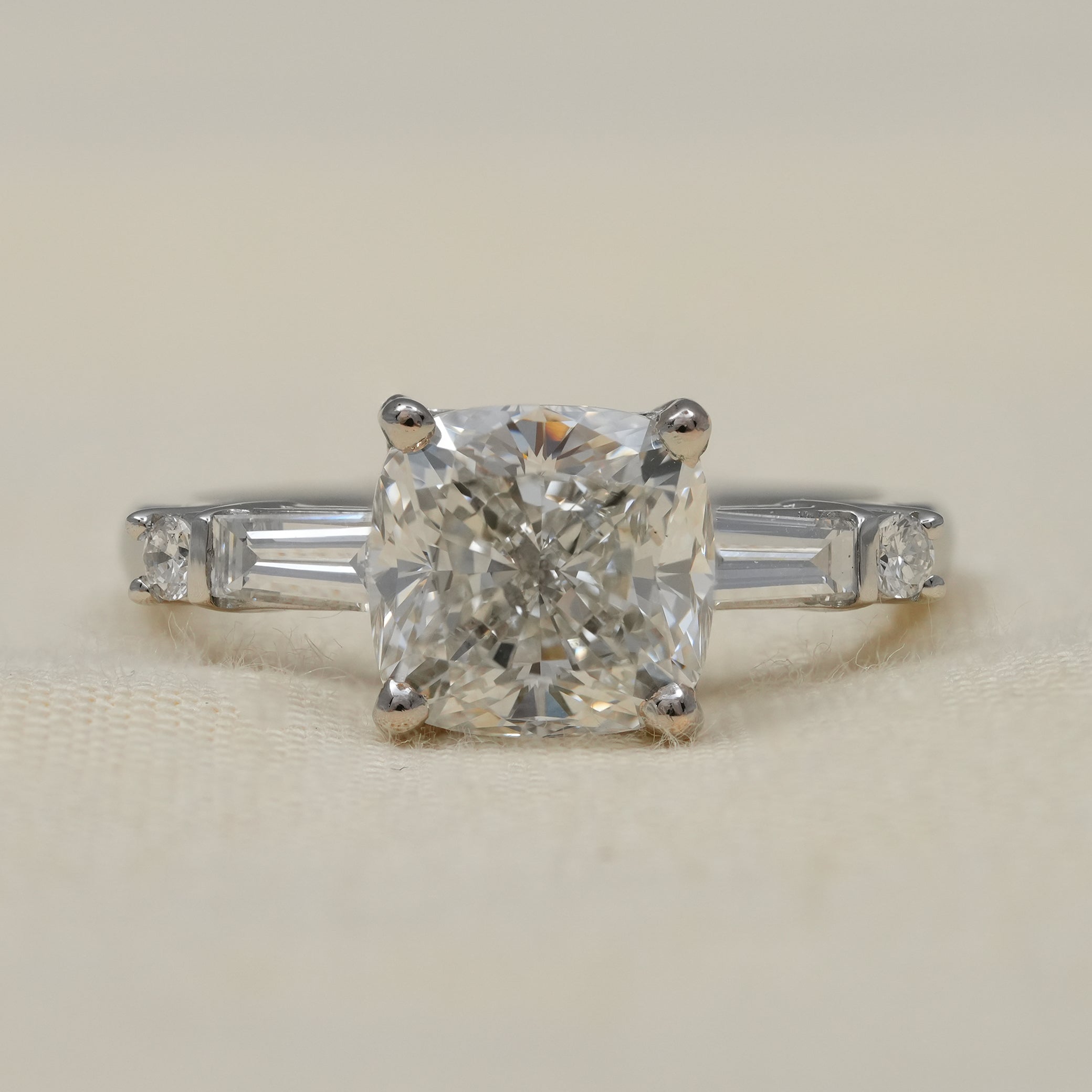 Cushion lab grown diamond engagement ring with tapered baguette sides