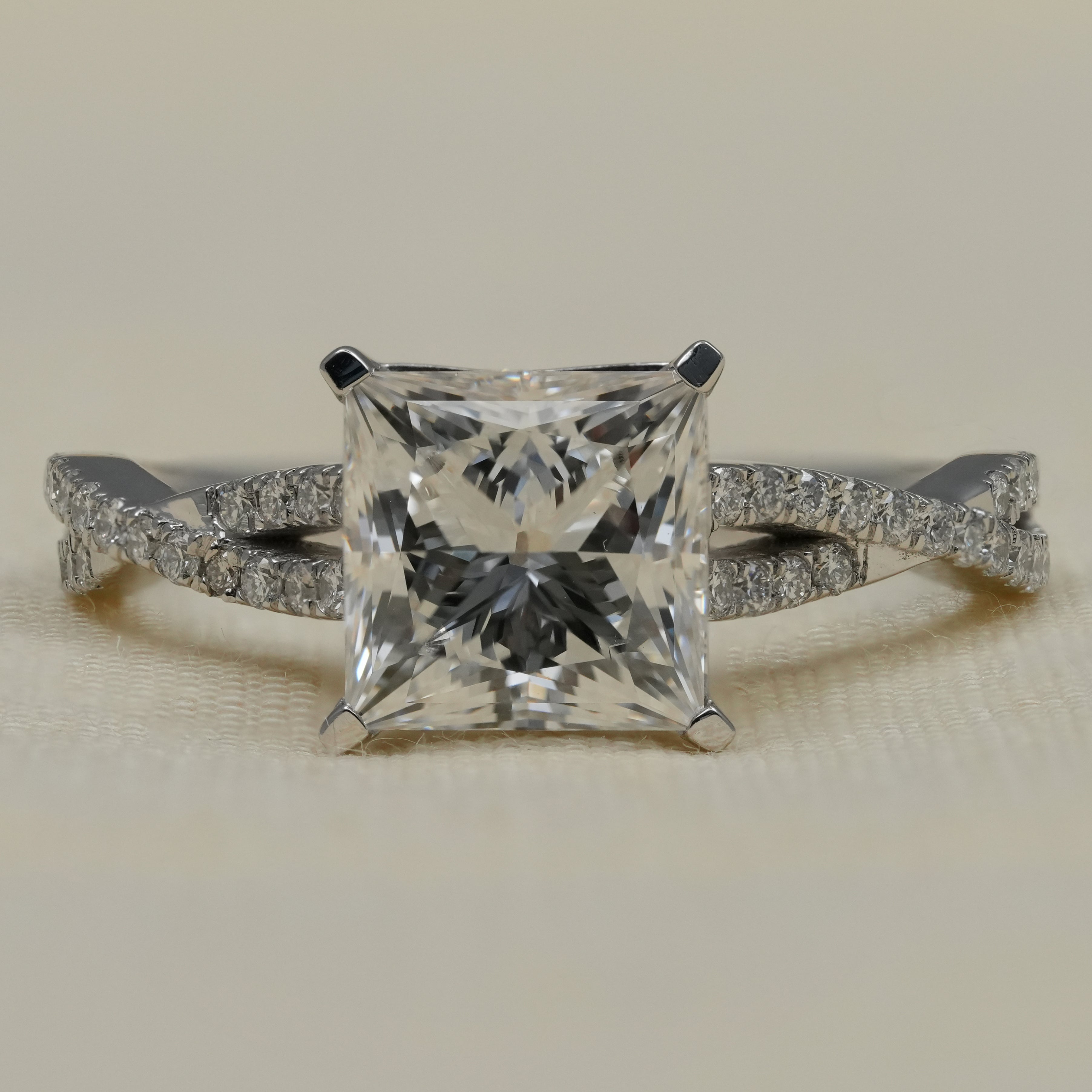 Princess cut lab grown diamond engagement ring with twisted pavé band