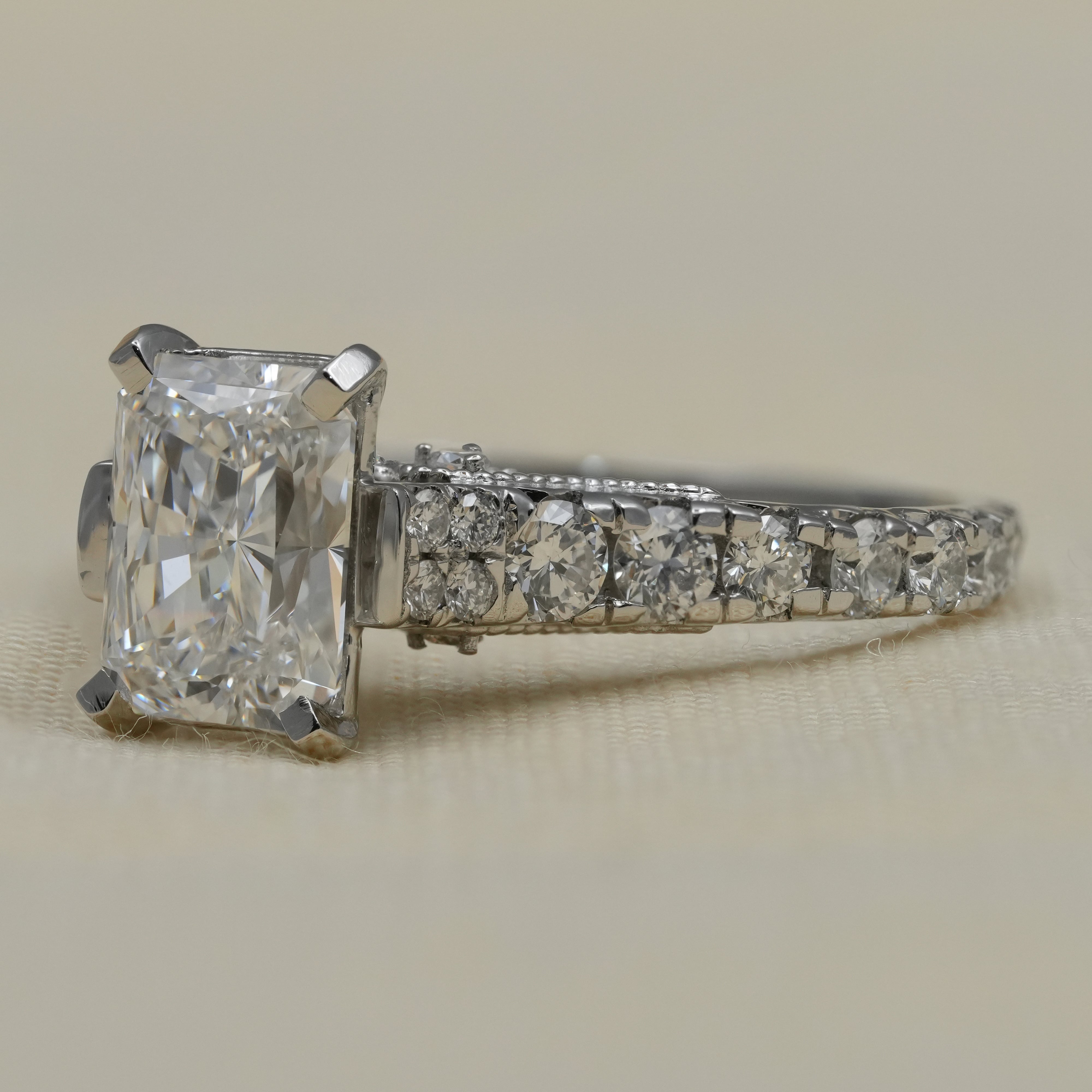 Elegant white gold radiant lab grown diamond ring vintage inspired shoulders.