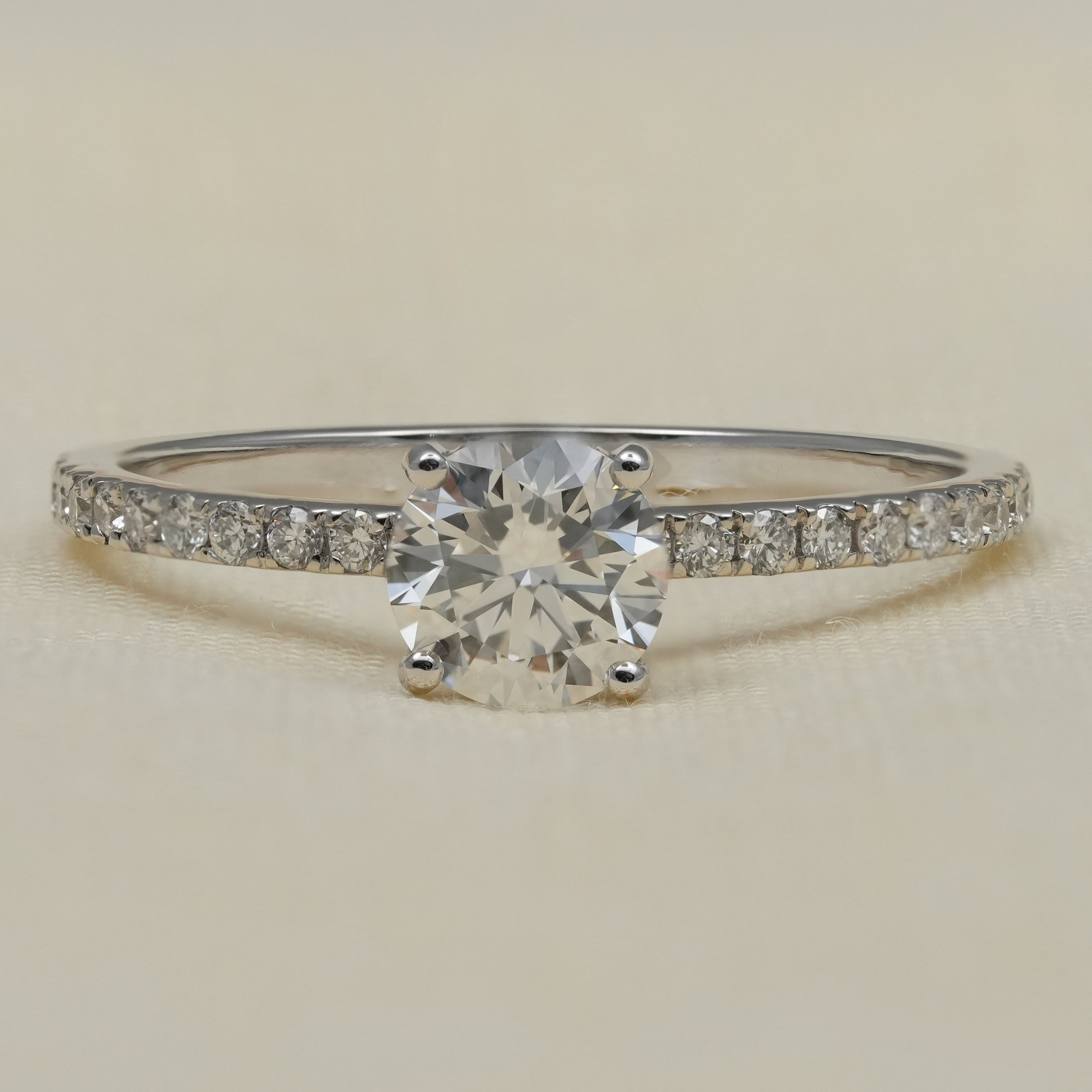 Round lab grown diamond solitaire engagement ring with pavé band