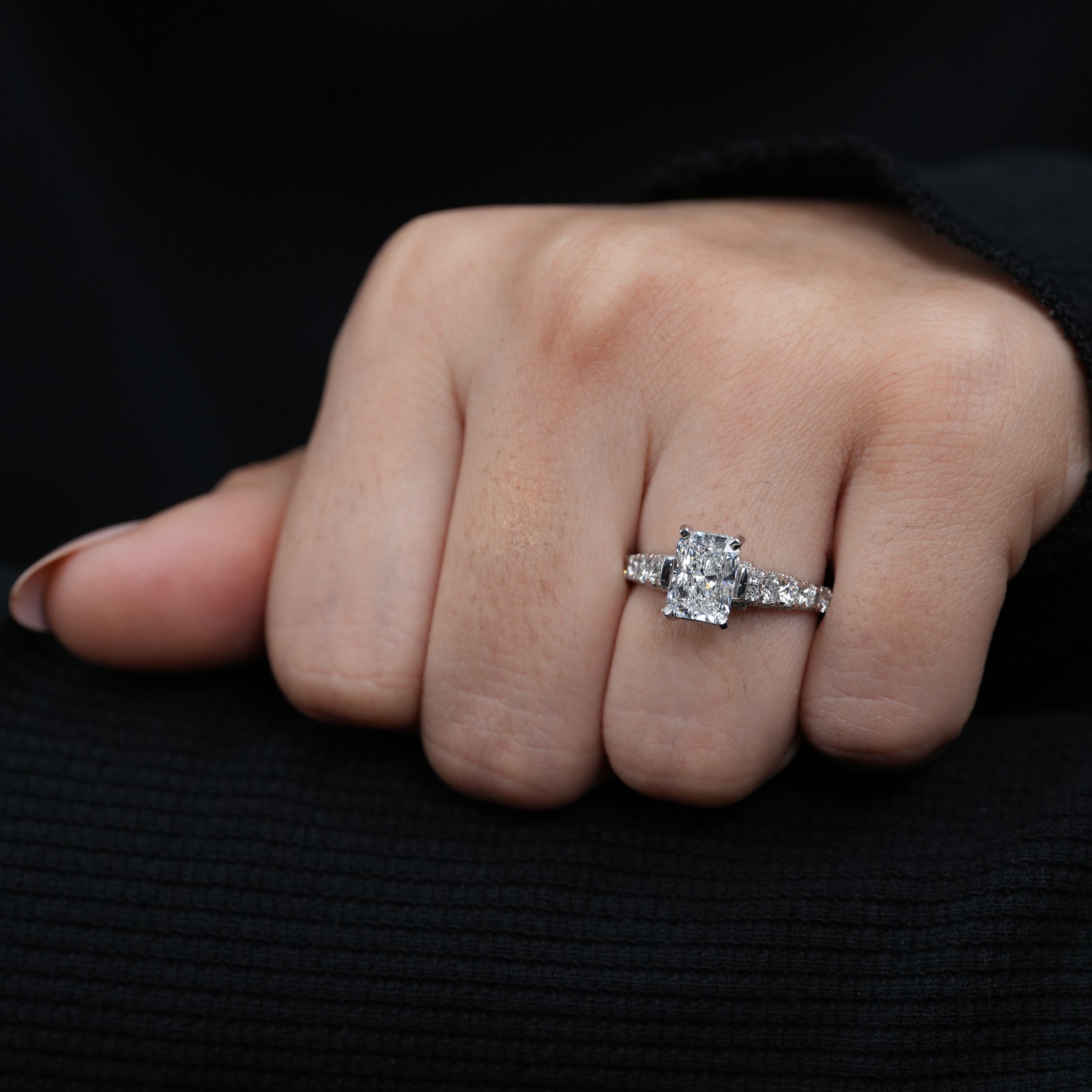 Fine jewelry radiant lab grown diamond ring with graduated round side stones.