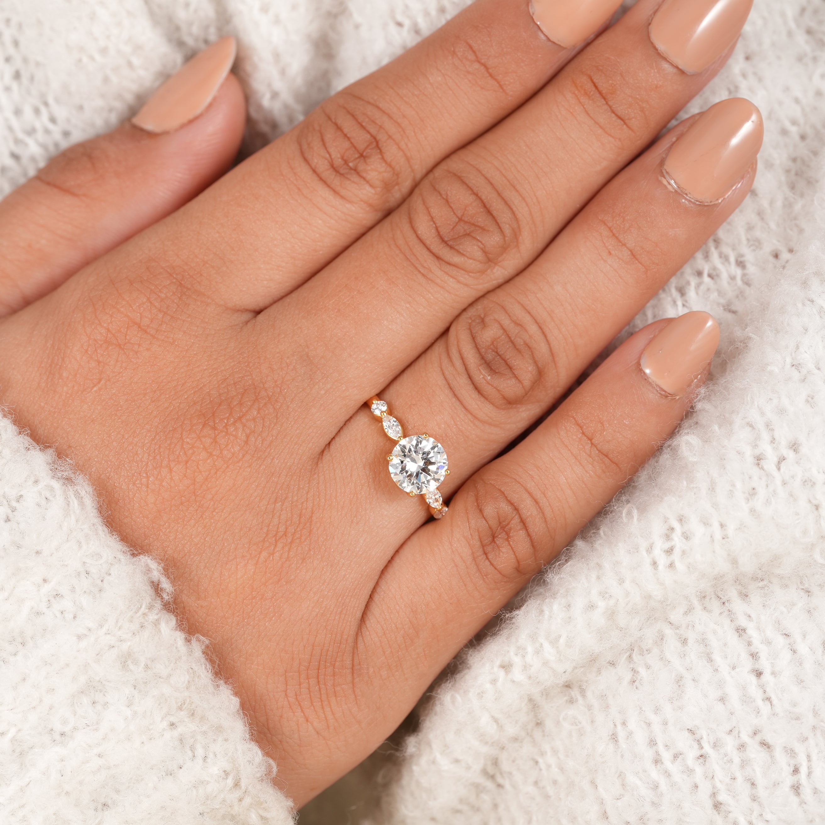 Round brilliant diamond ring with vintage inspired marquise side stones