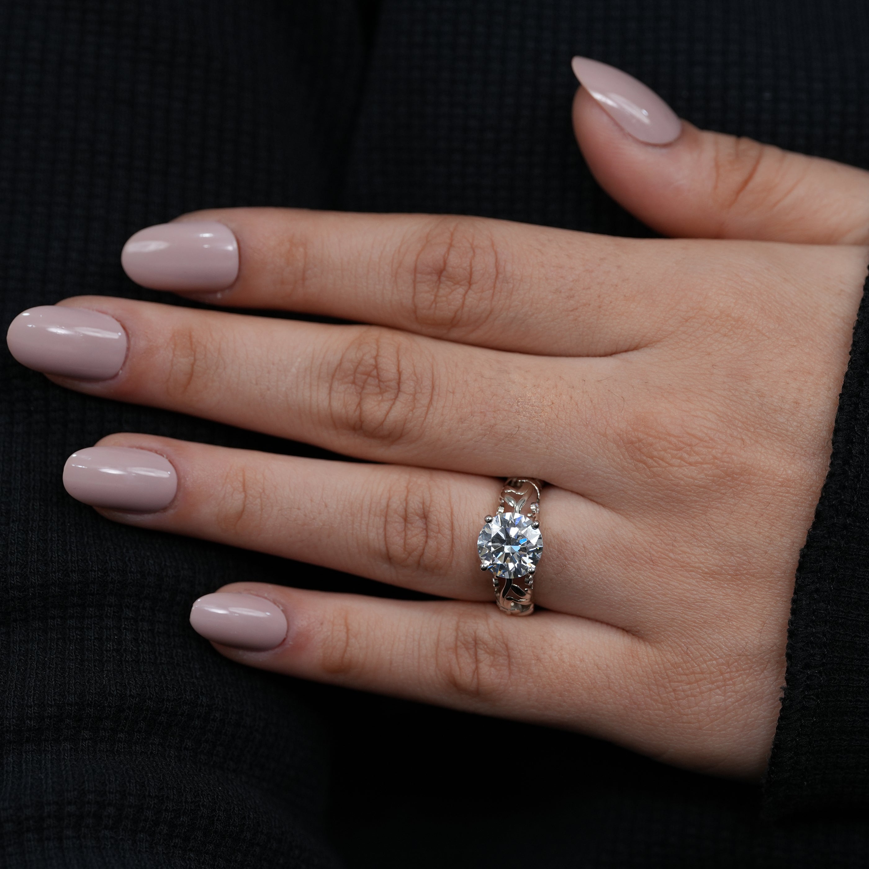 Nature inspired engagement ring featuring round lab grown diamond and flowing gold vines