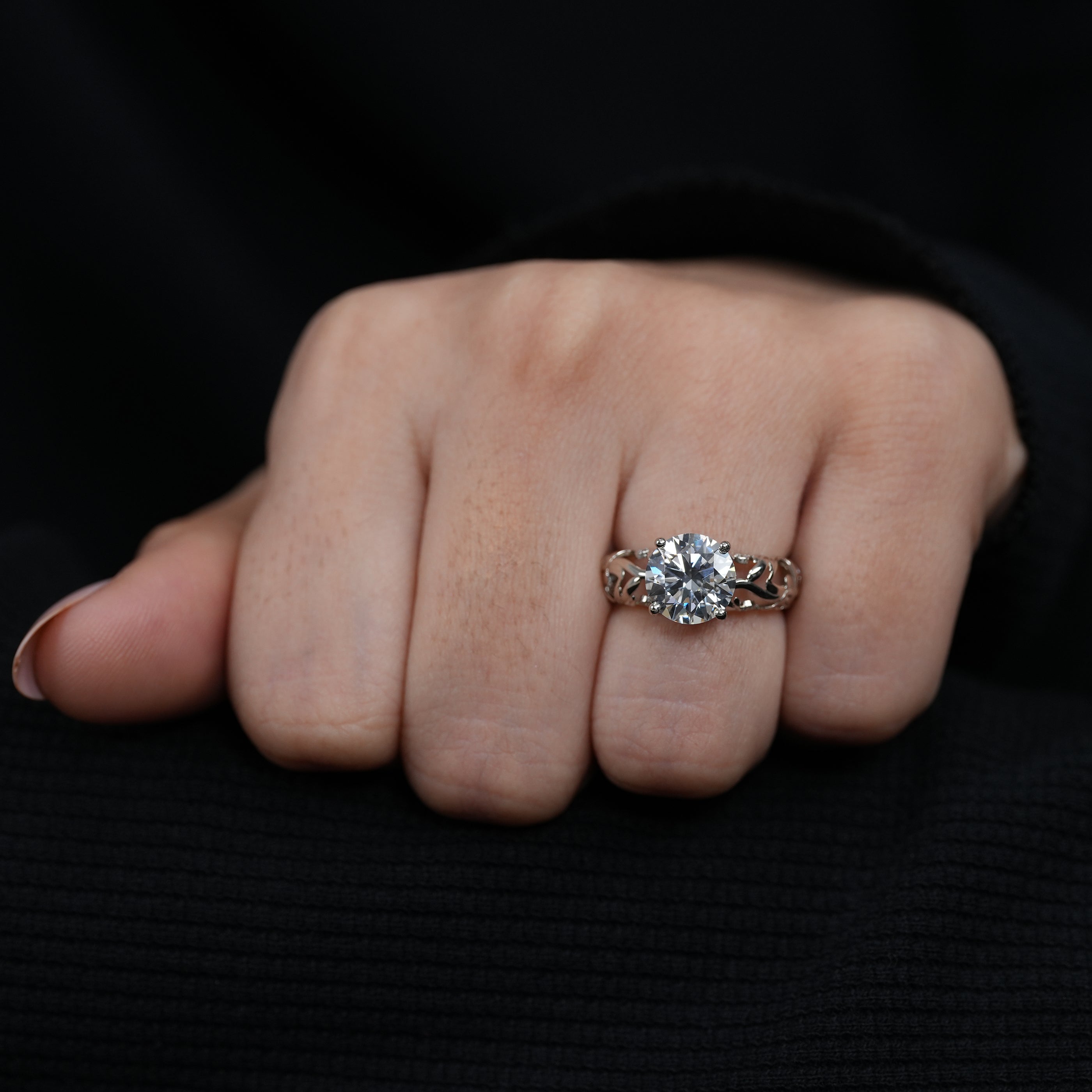 Artisan sculpted gold band holding round lab grown diamond solitaire centerpiece