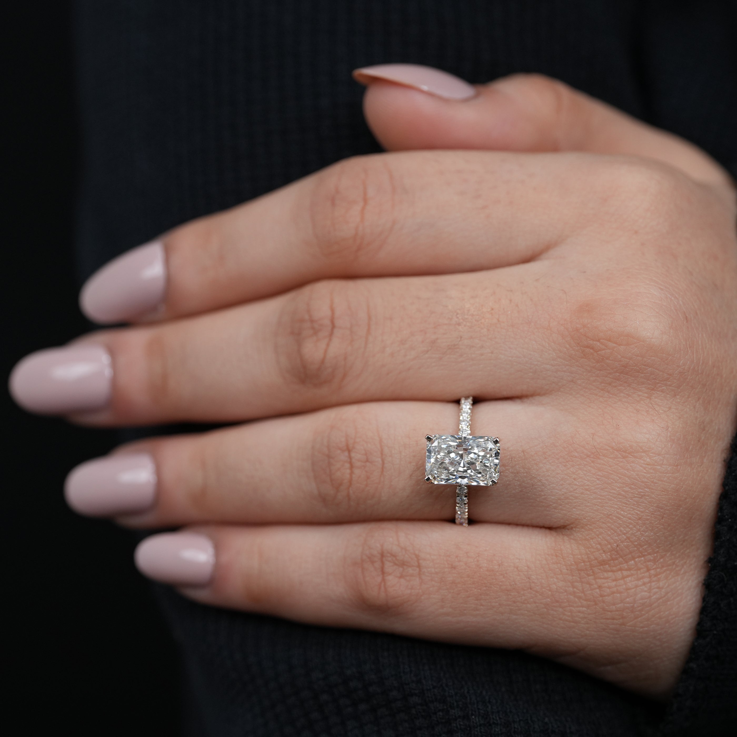 Modern rectangular lab grown diamond solitaire ring polished gold pavé shoulders.