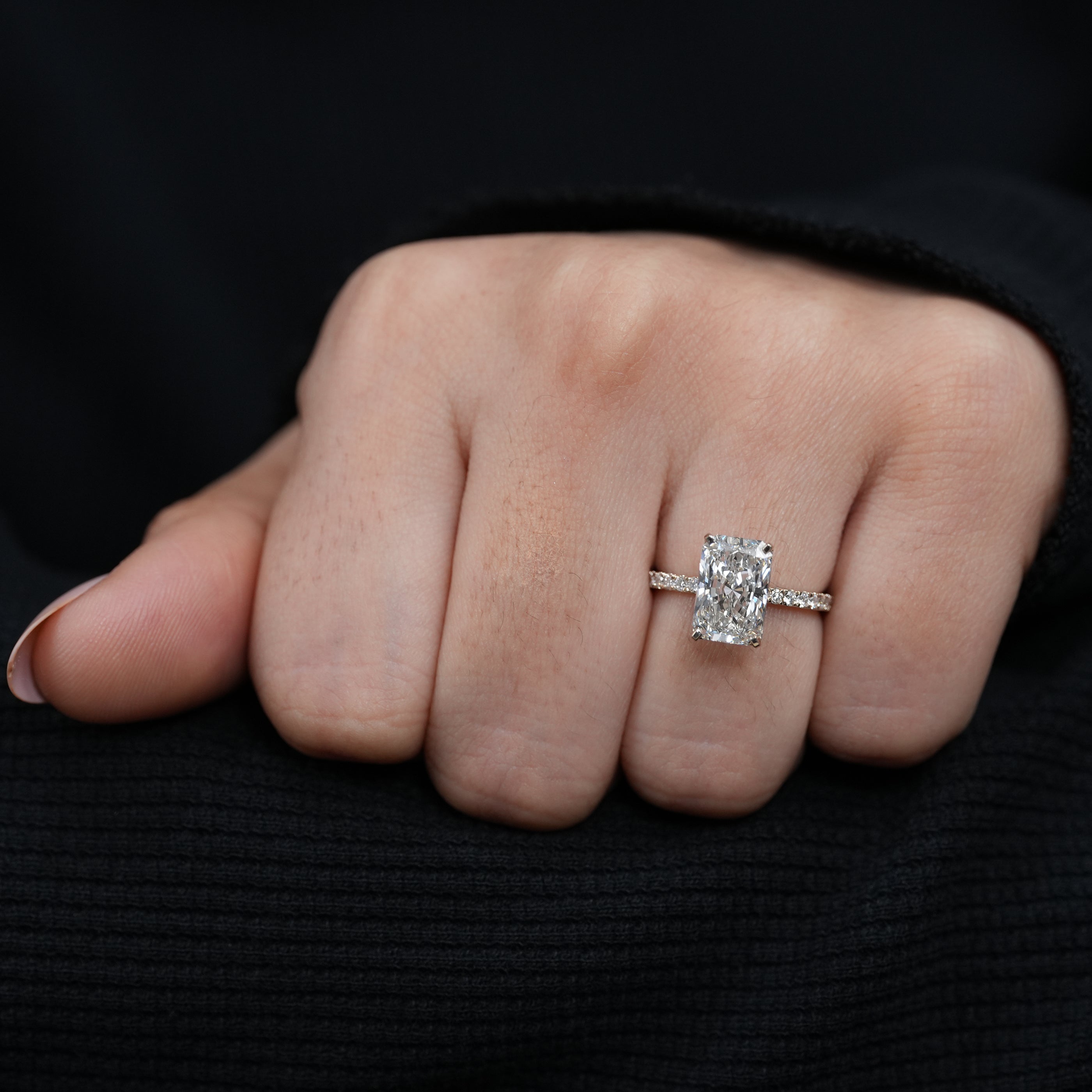 Fine jewelry radiant lab grown diamond proposal ring slim yellow gold pavé band.