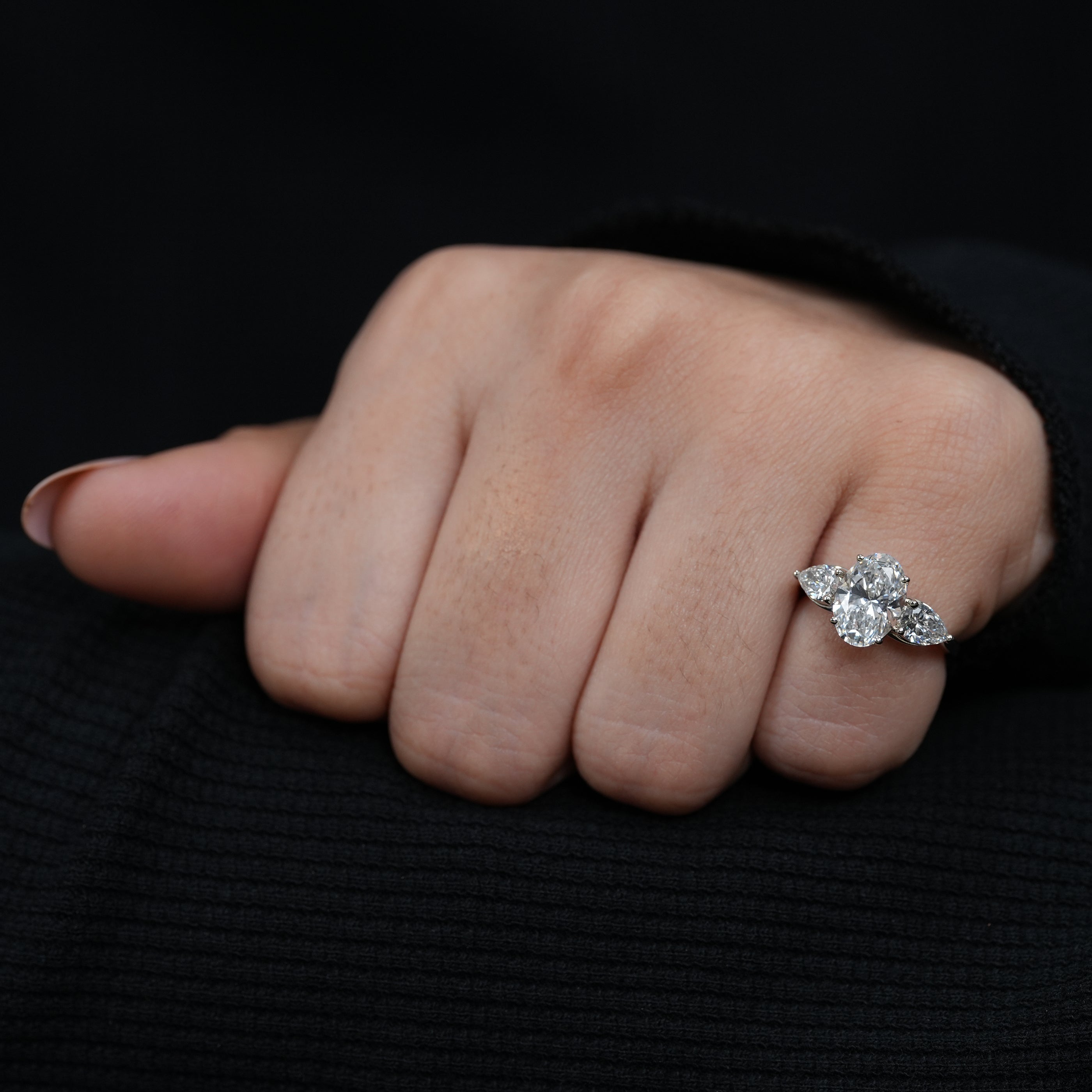 Romantic oval lab grown diamond ring framed by matching pear side stones
