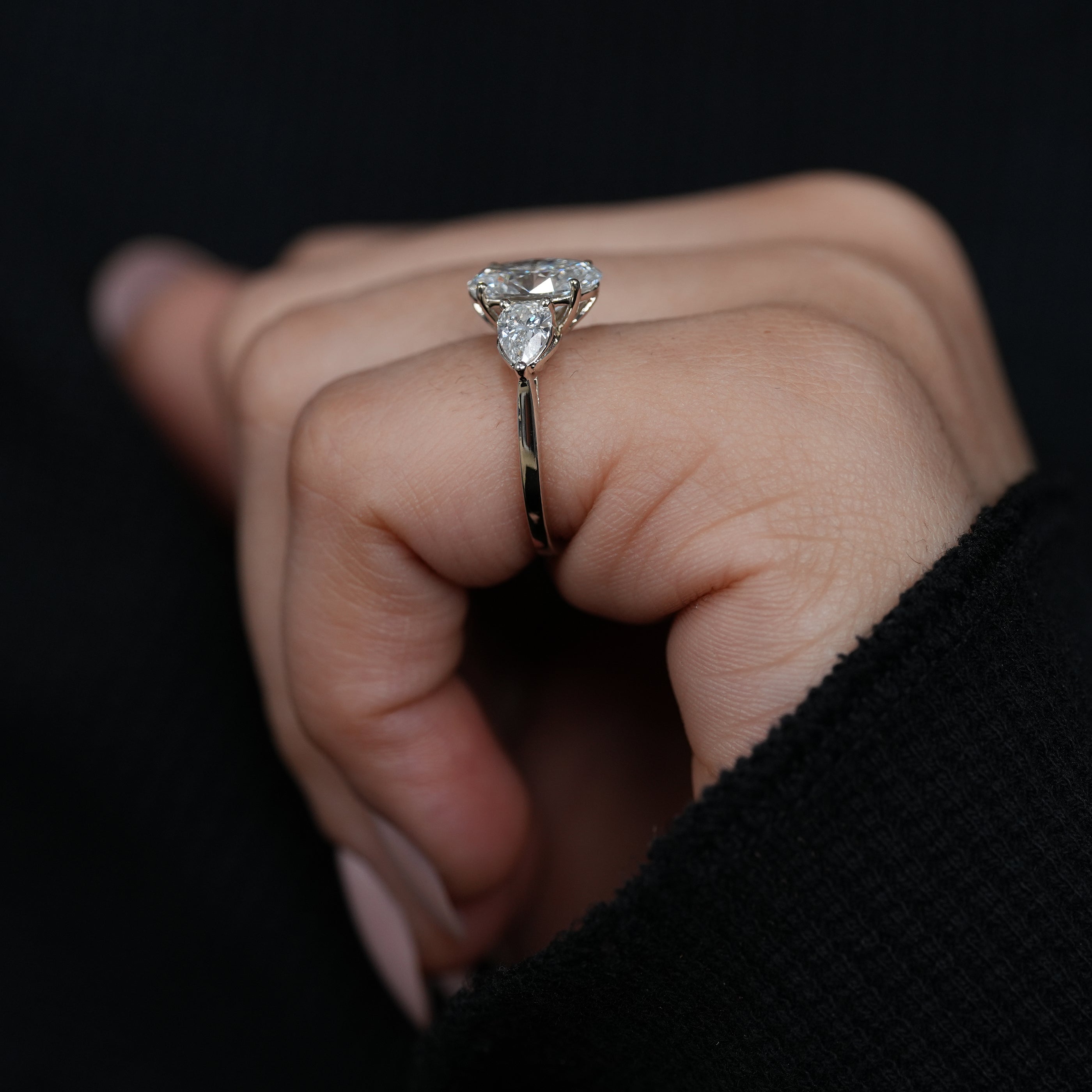 Modern oval lab grown diamond ring balanced with pear shaped side diamonds