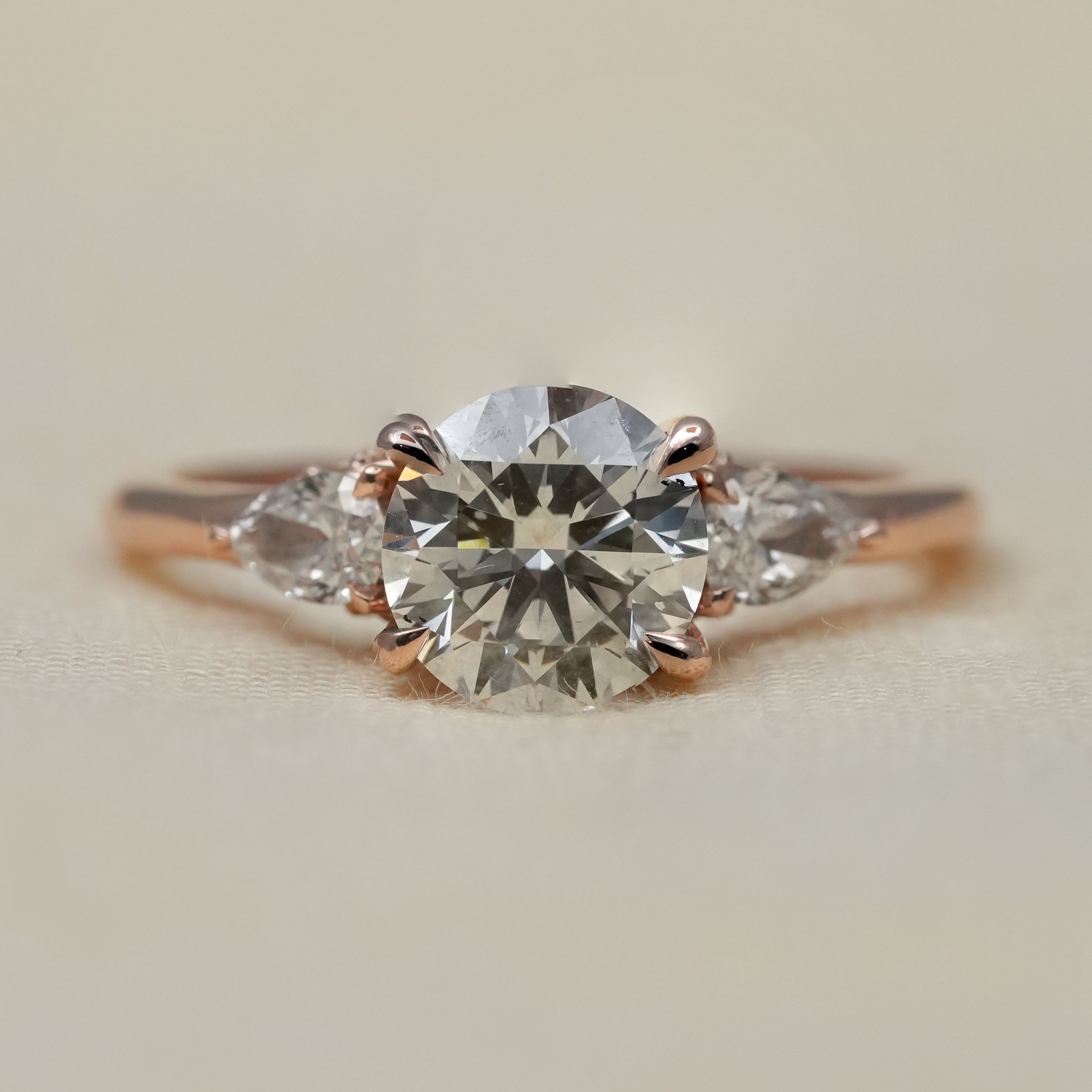 Round lab grown diamond three stone engagement ring rose gold