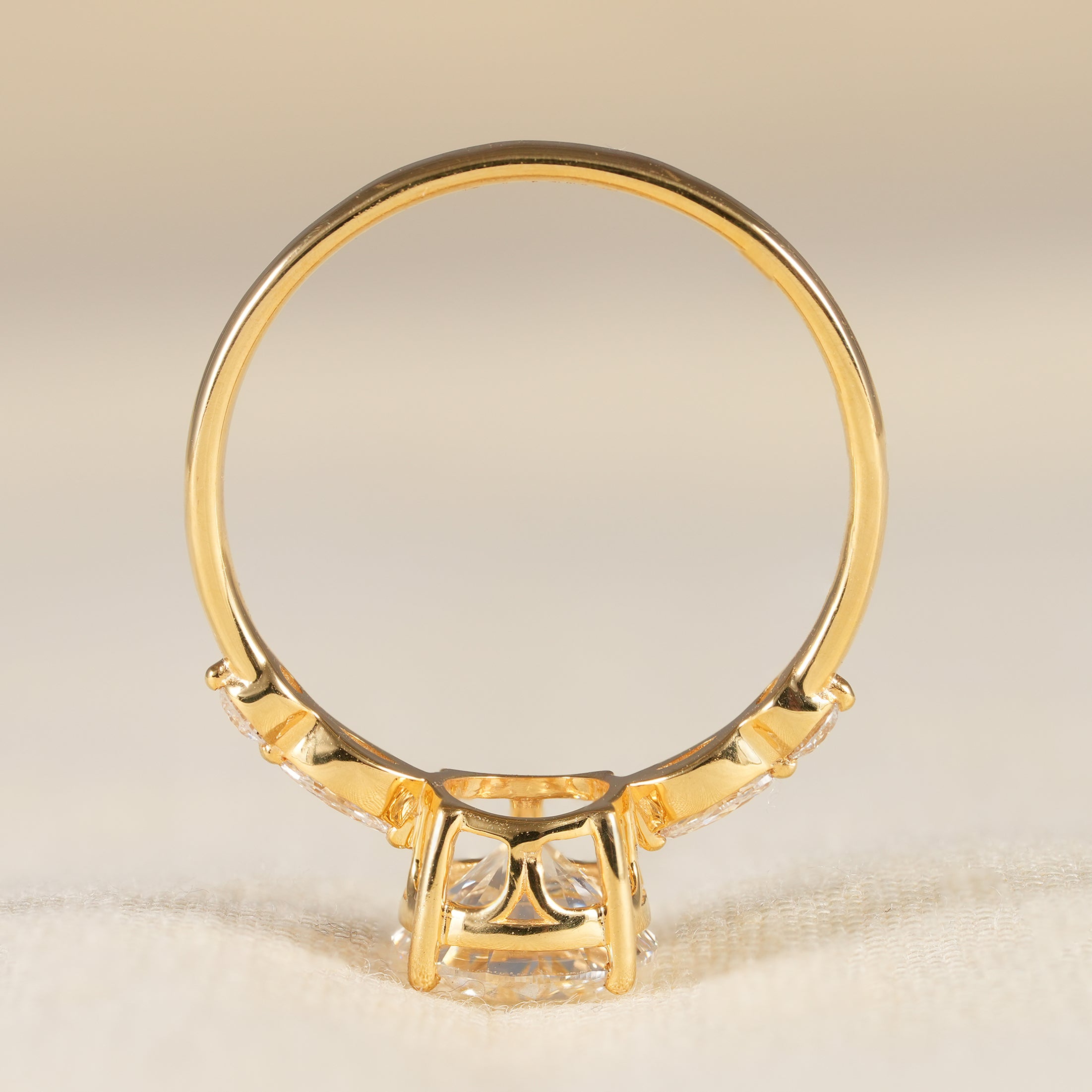 Yellow gold round diamond ring with marquise diamond accent setting