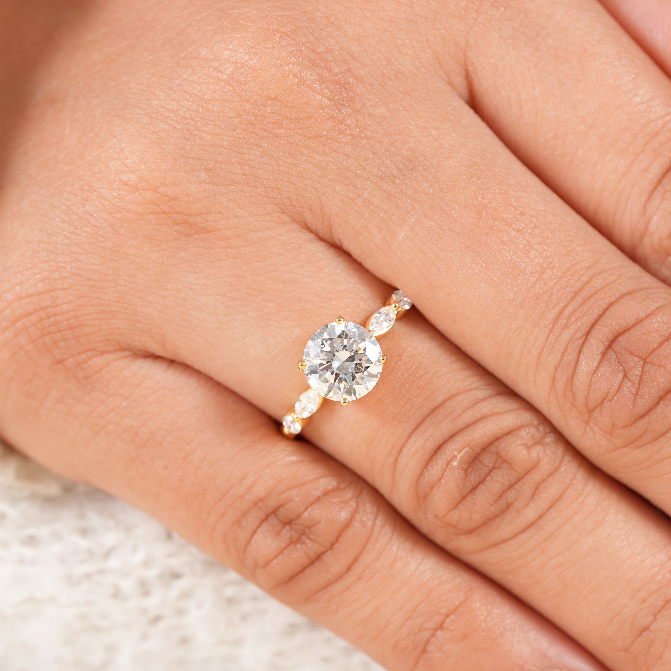 Dainty round diamond solitaire ring with marquise and round side diamonds