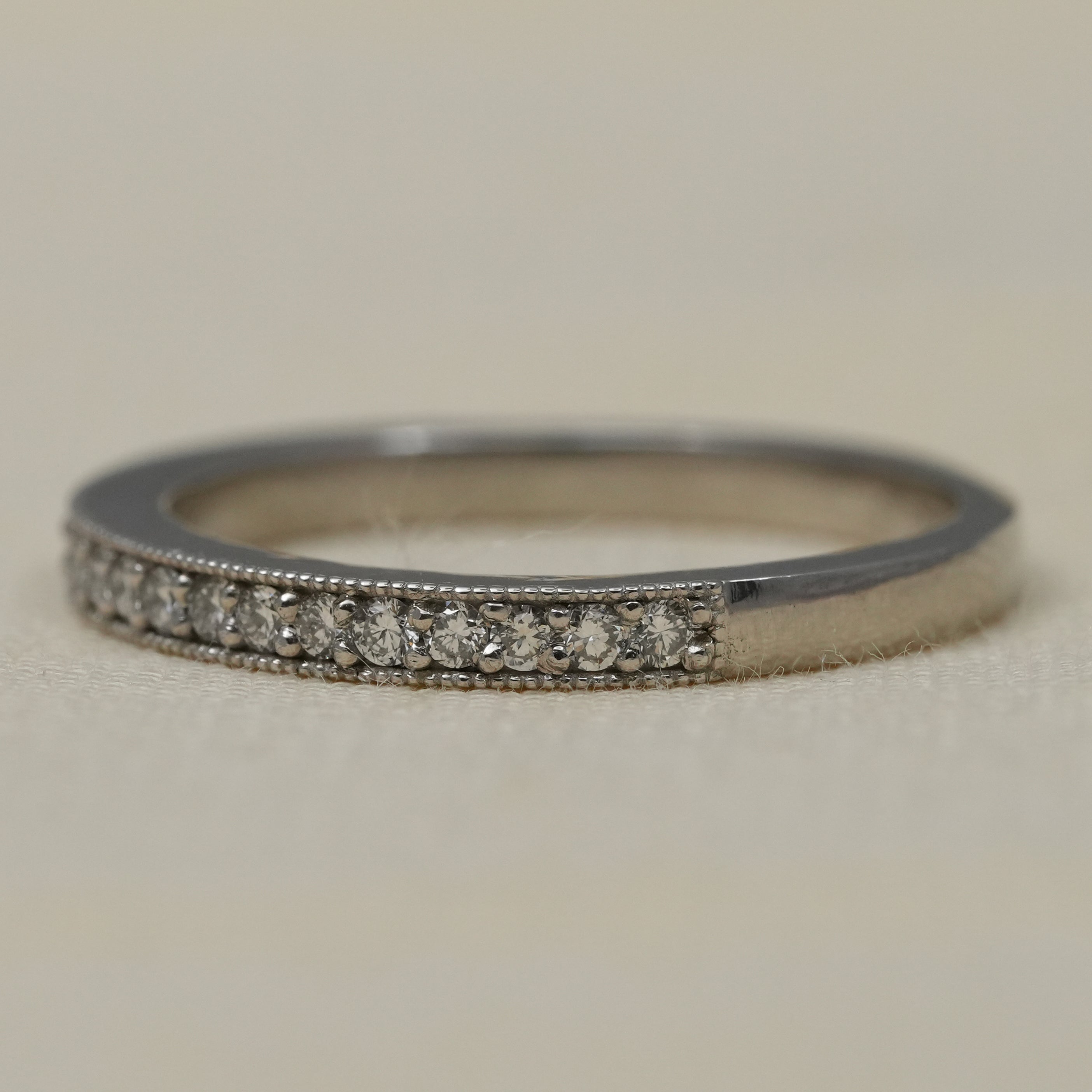 Delicate lab grown diamond stacking ring in polished white gold milgrain