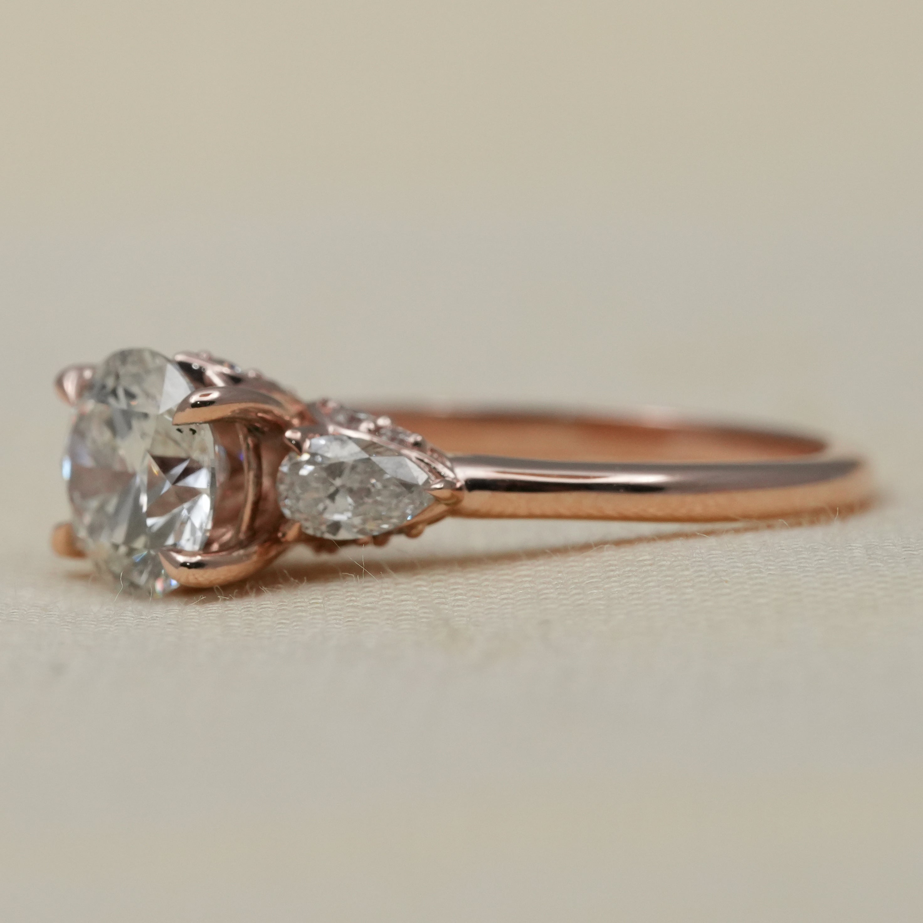Classic round lab grown diamond ring with pear side stones
