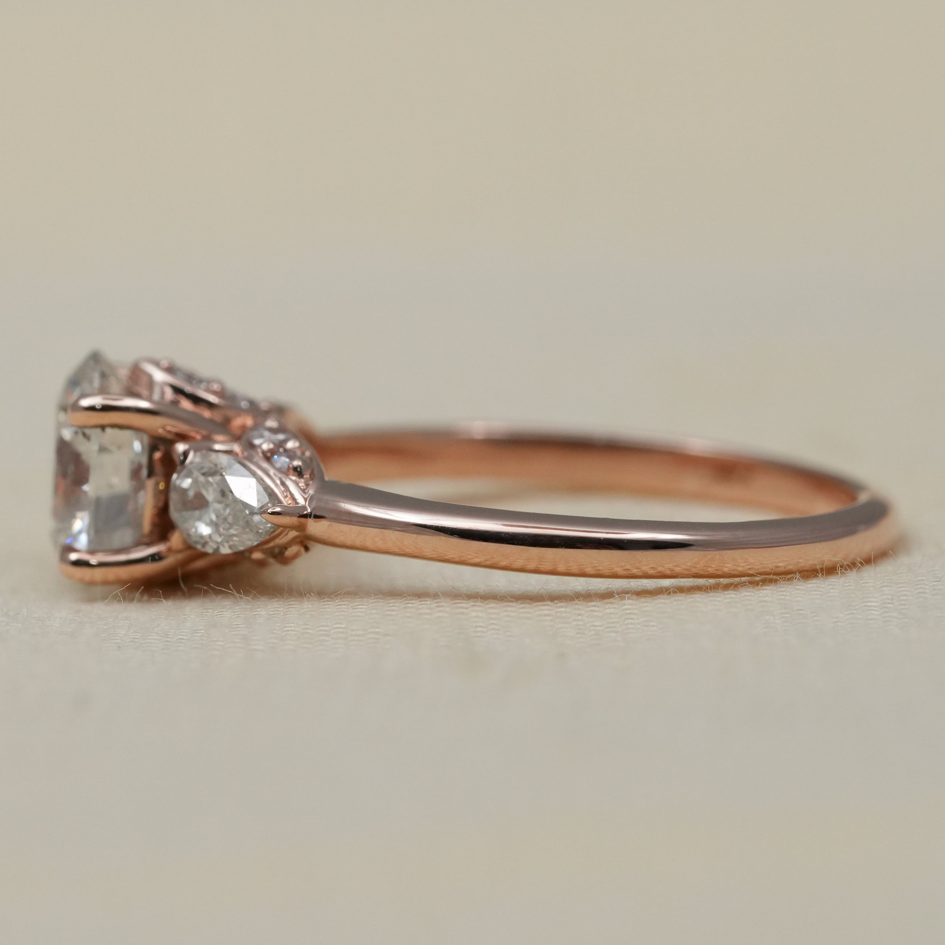 Elegant three stone lab grown diamond ring warm rose gold setting