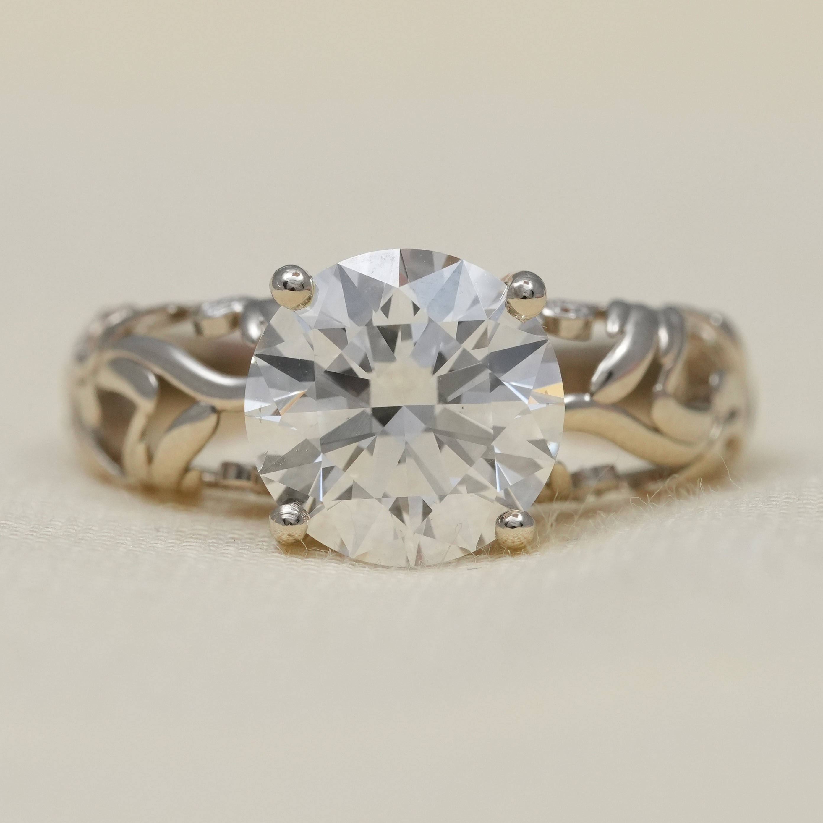 Round lab grown diamond solitaire on two tone vine engraved gold engagement ring