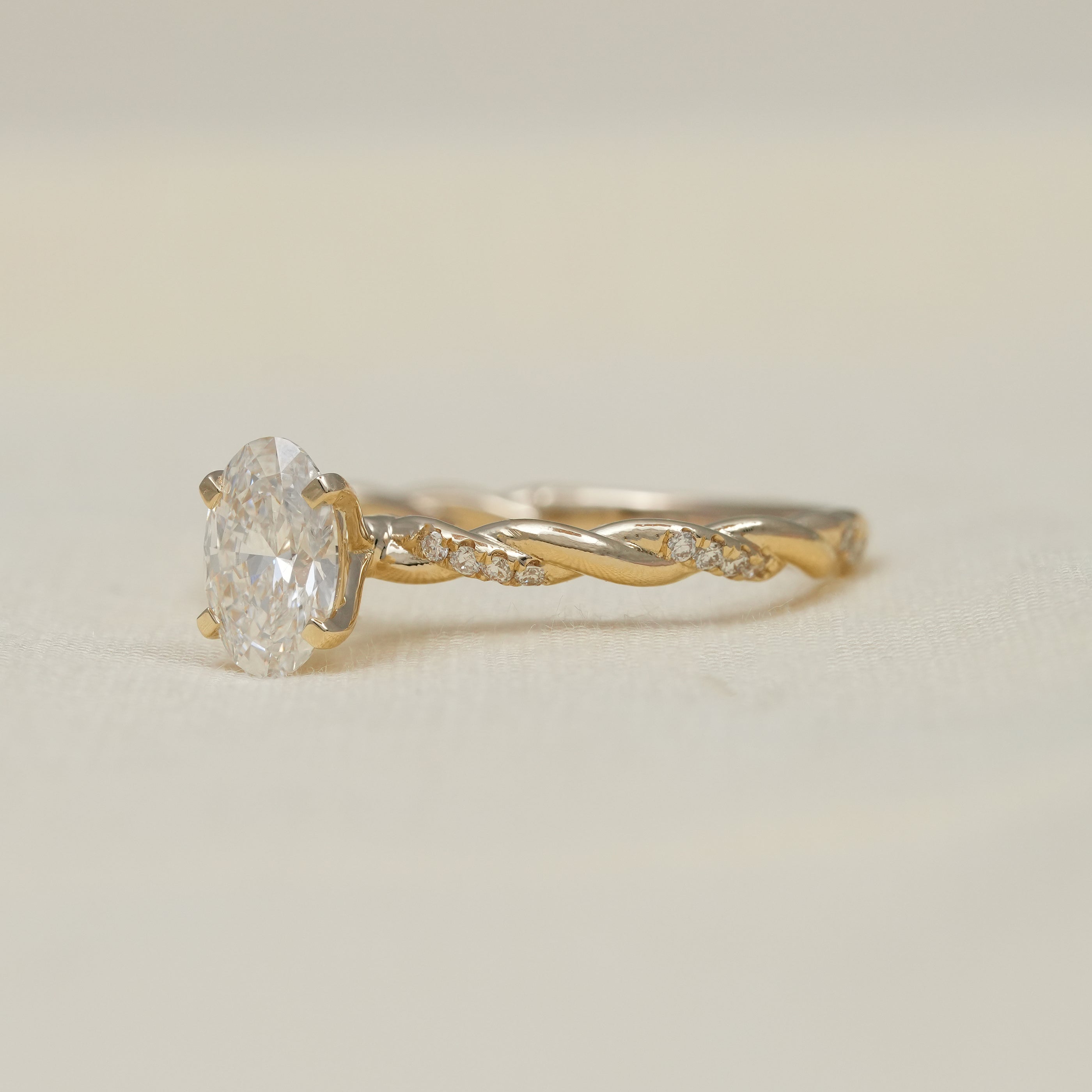 Elegant oval lab grown diamond ring with vine style yellow gold shank