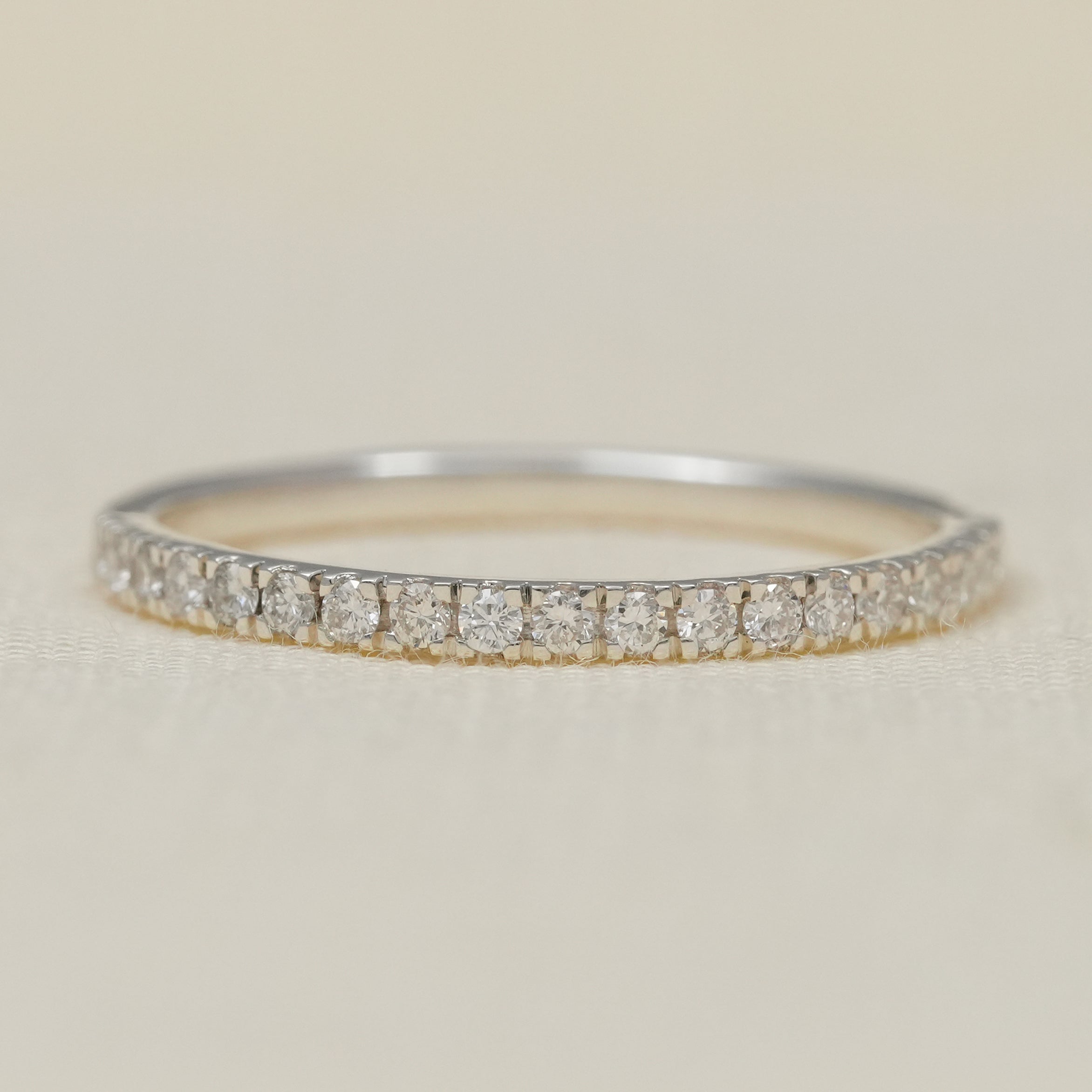 Minimalist lab grown diamond pavé wedding band in two tone gold.