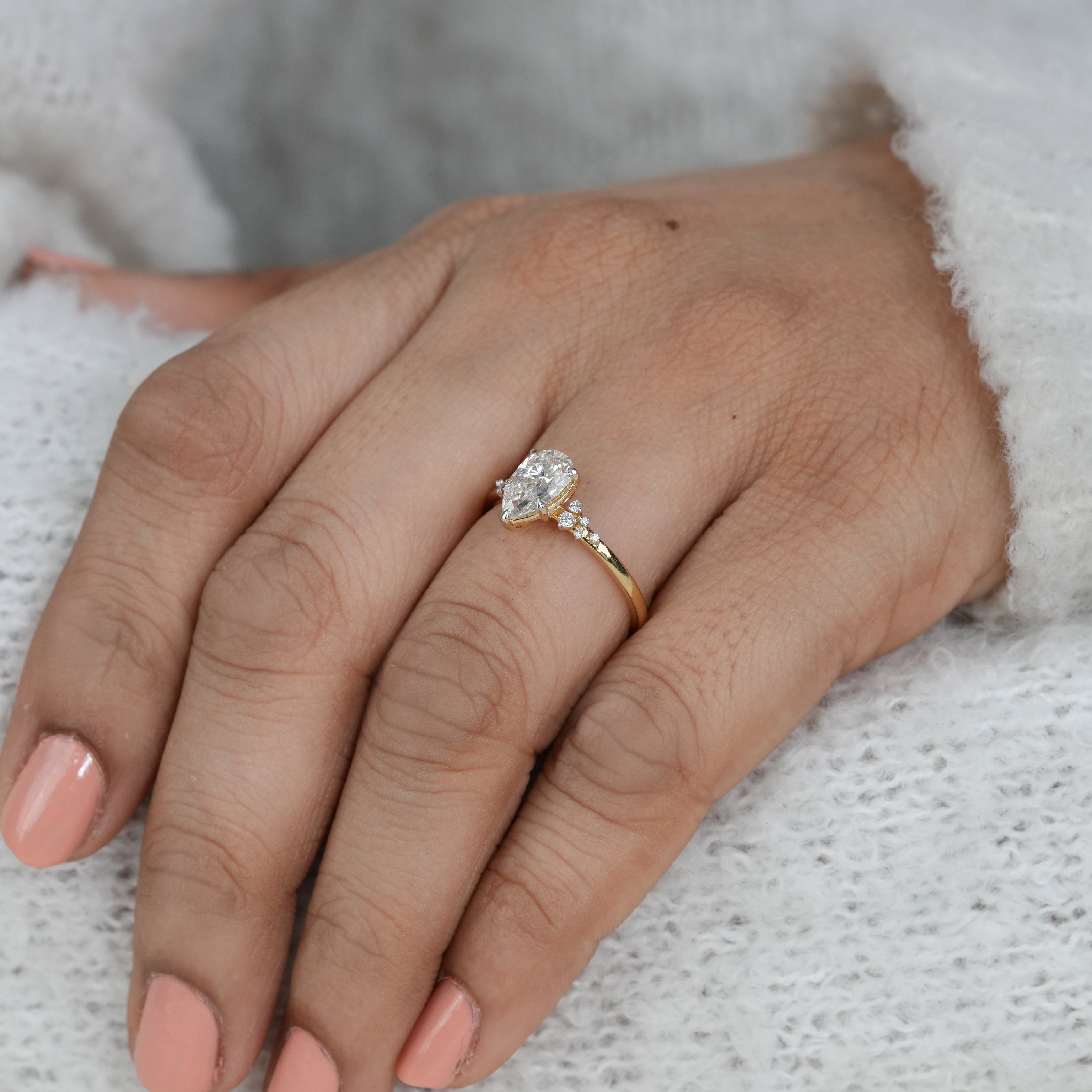 Close up pear lab grown diamond ring with elegant accent detailing