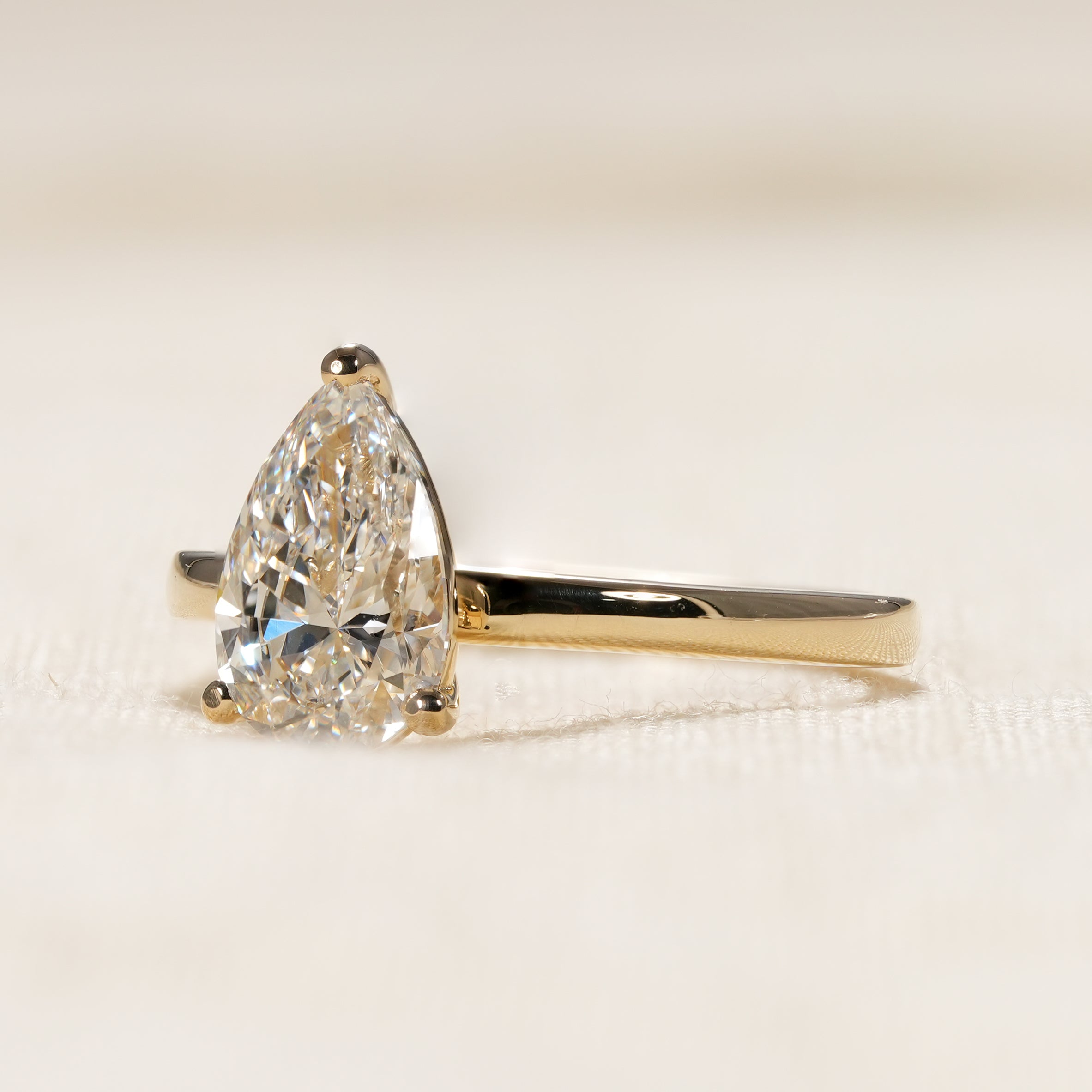 Elegant pear cut diamond engagement ring with timeless solitaire setting