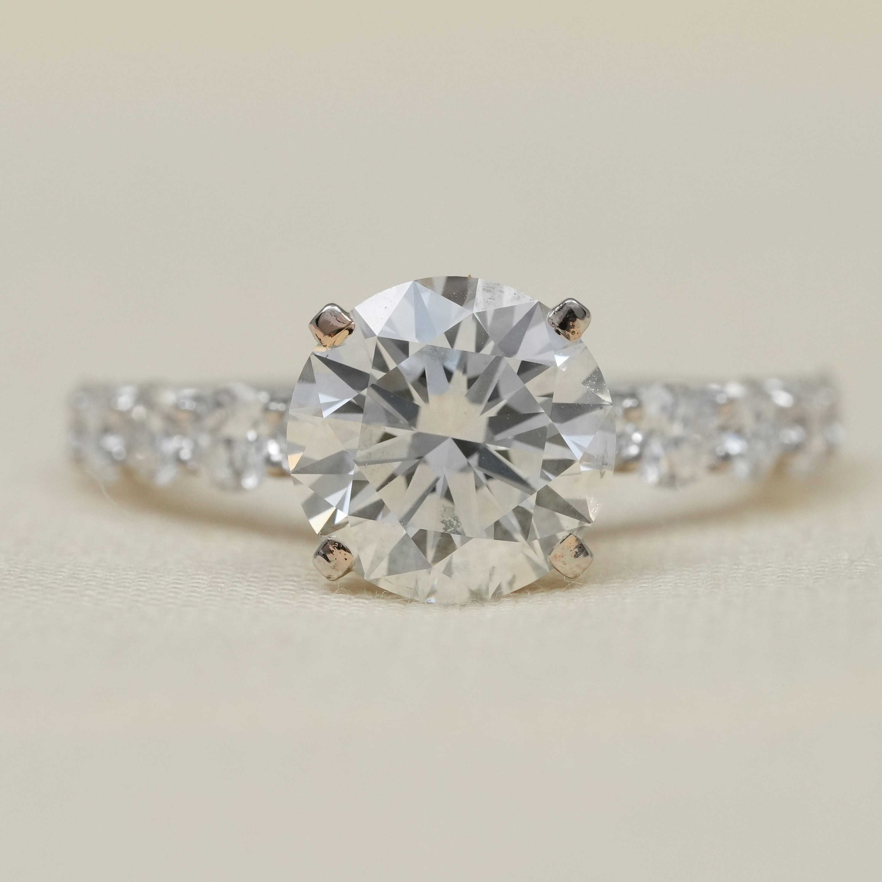 Round lab grown diamond solitaire engagement ring with pavé band white gold