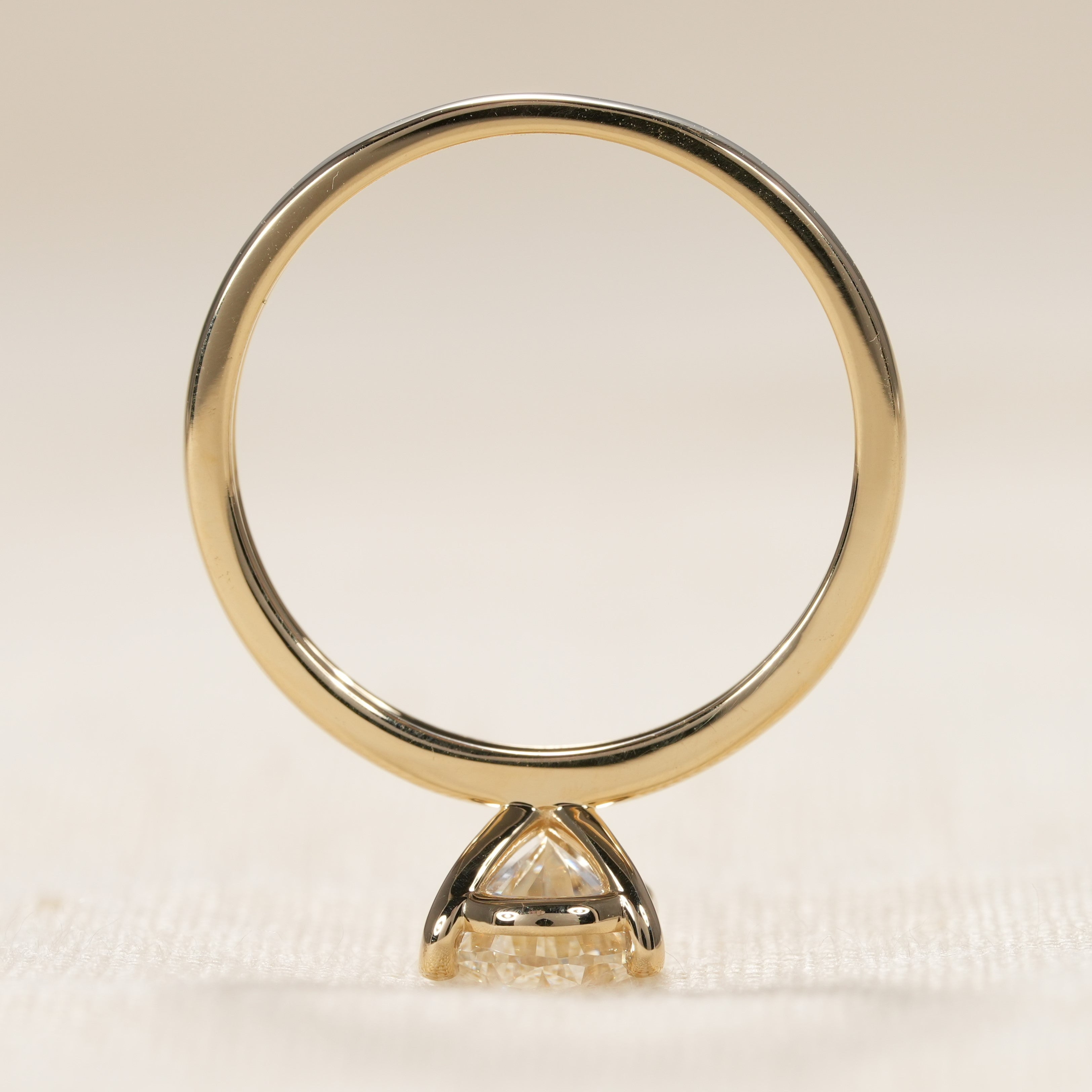 Pear cut solitaire engagement ring with modern four prong gold setting