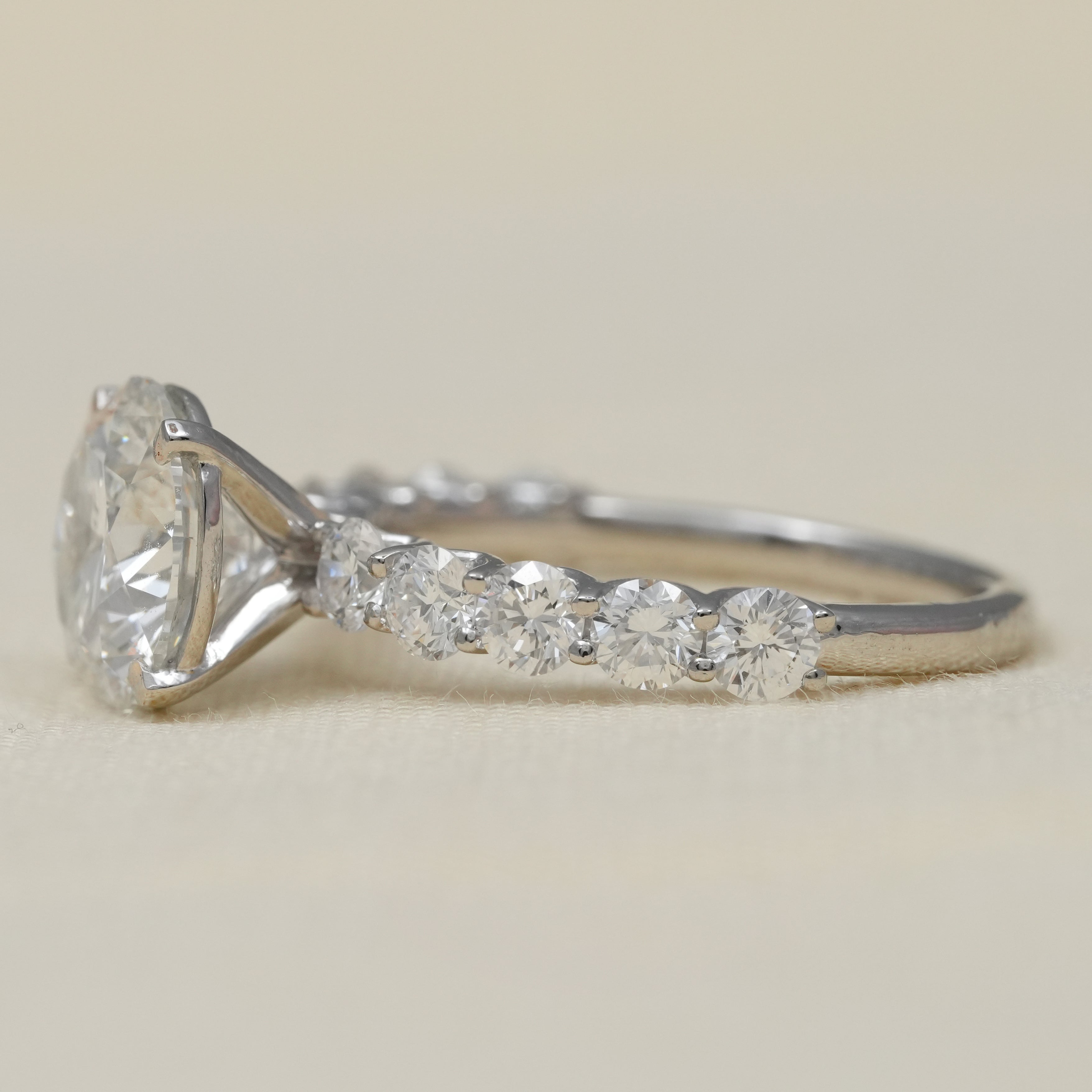 Classic round lab grown diamond engagement ring delicate pavé shoulders platinum
