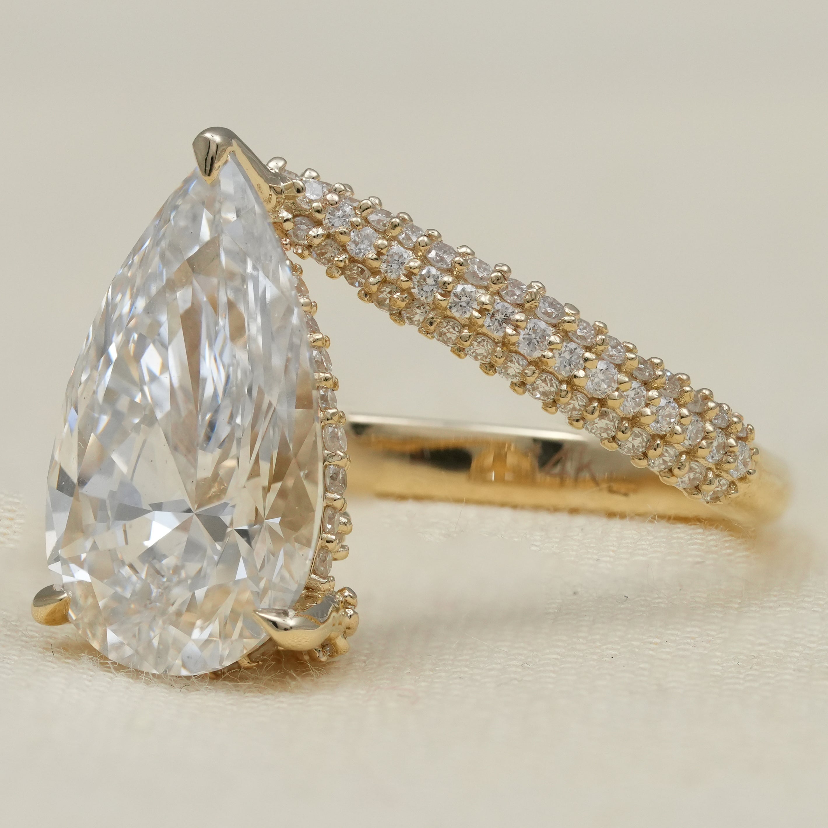 Modern pear lab grown diamond ring with curved pavé diamond band