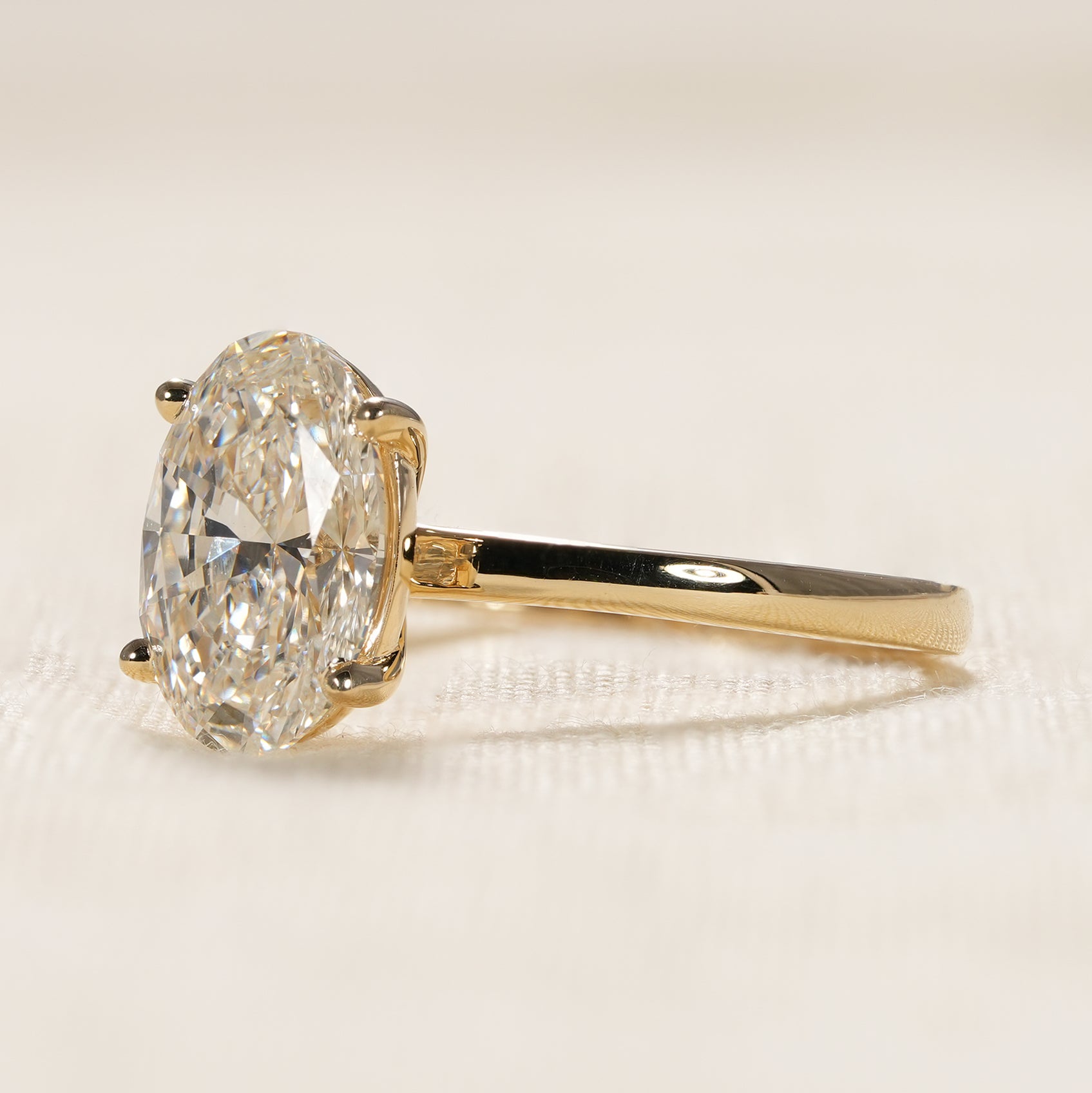 Timeless oval cut diamond engagement ring with minimalist yellow gold design