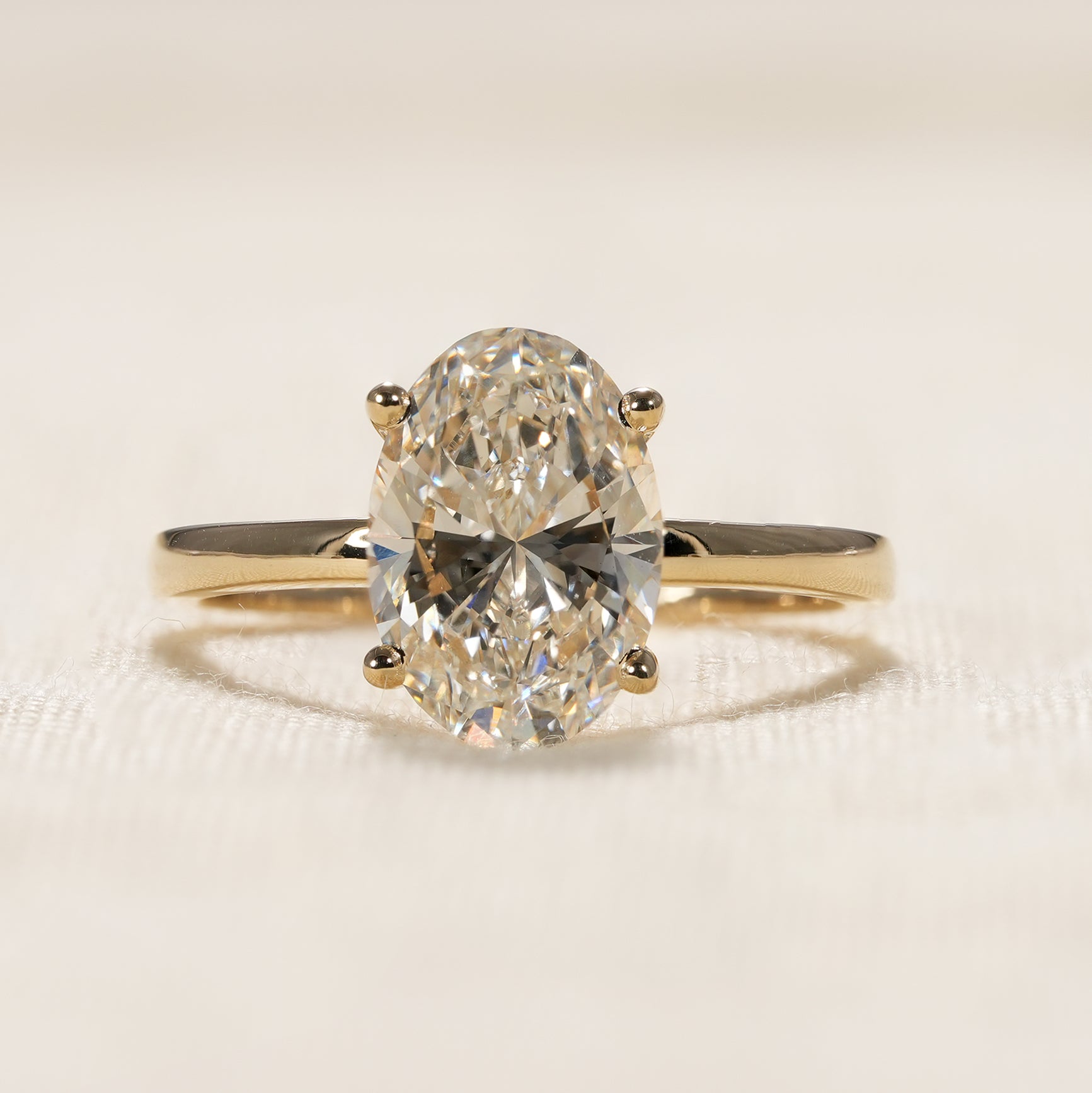 Classic oval cut lab diamond solitaire engagement ring in yellow gold setting
