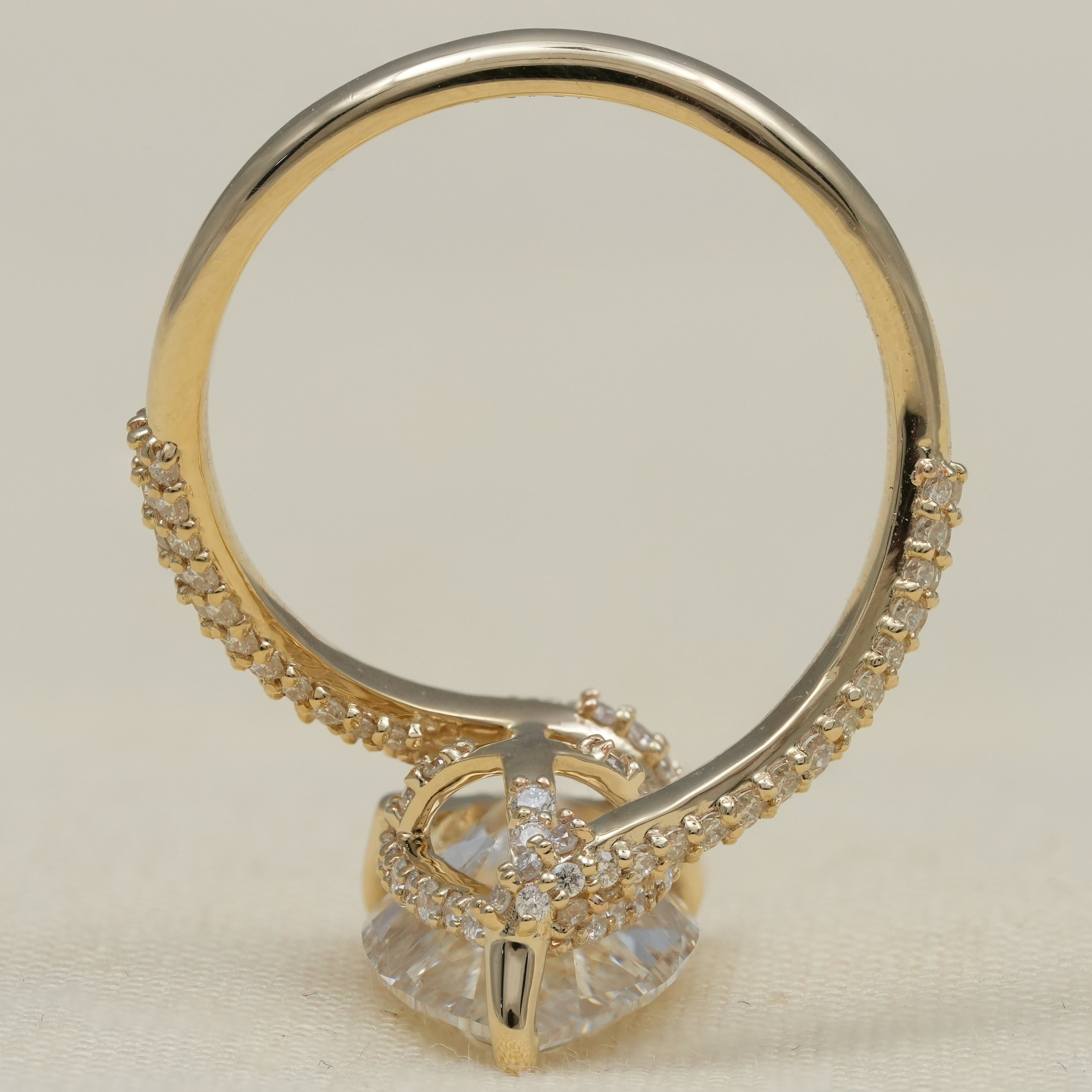 Sculptural gold ring featuring pear lab grown diamond and pavé accents