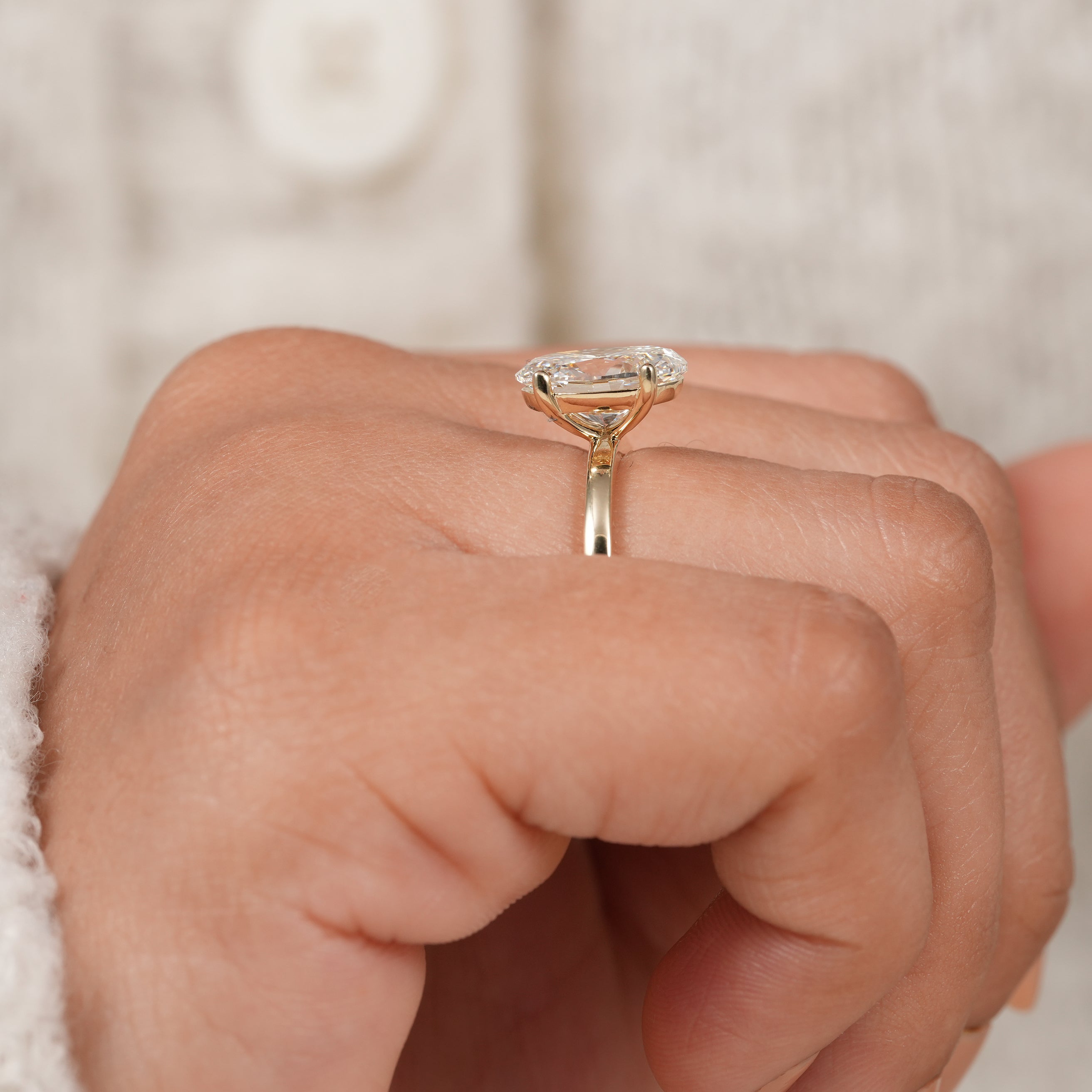 Oval solitaire engagement ring with polished yellow gold and modern elegance