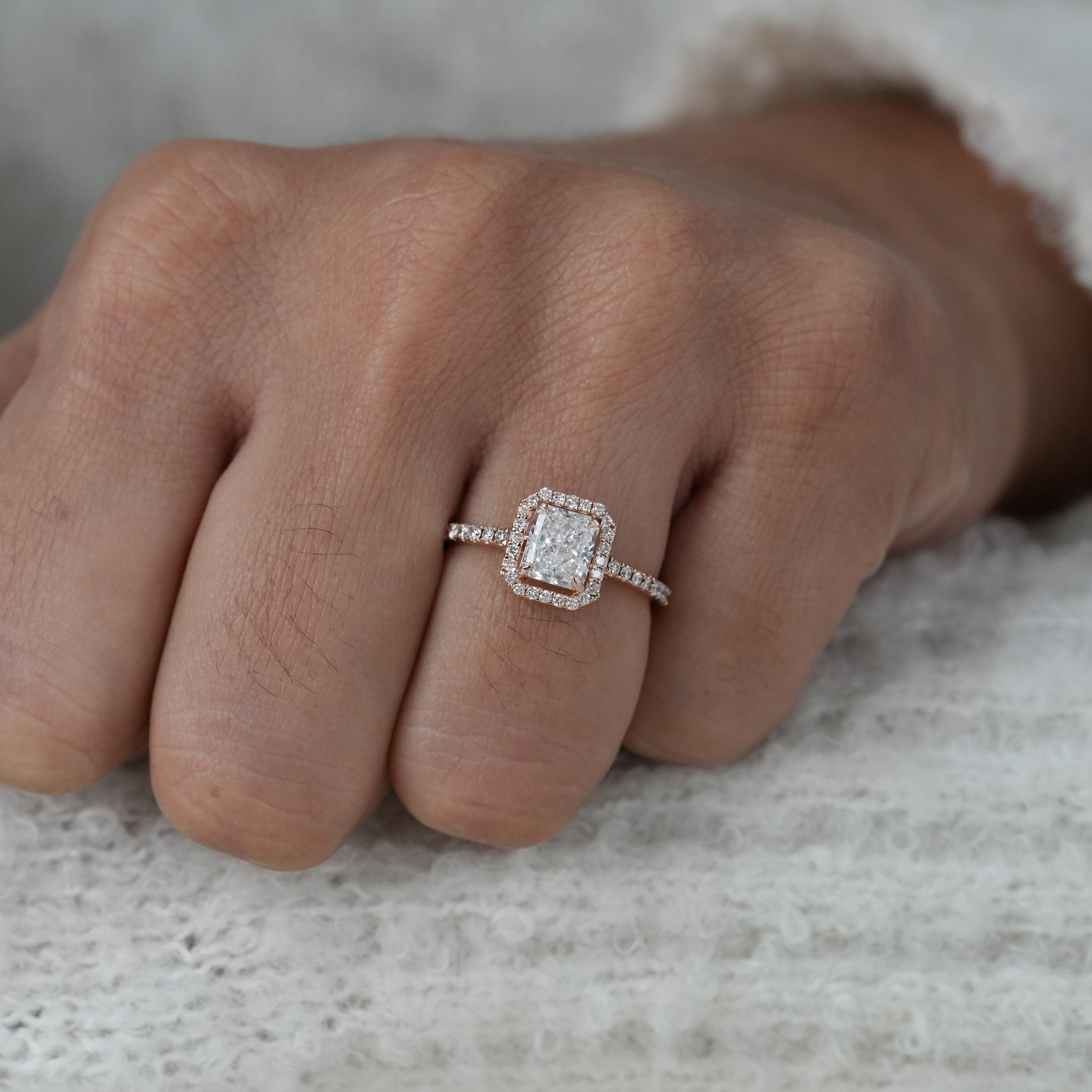 Modern radiant lab grown diamond ring with halo and pavé band