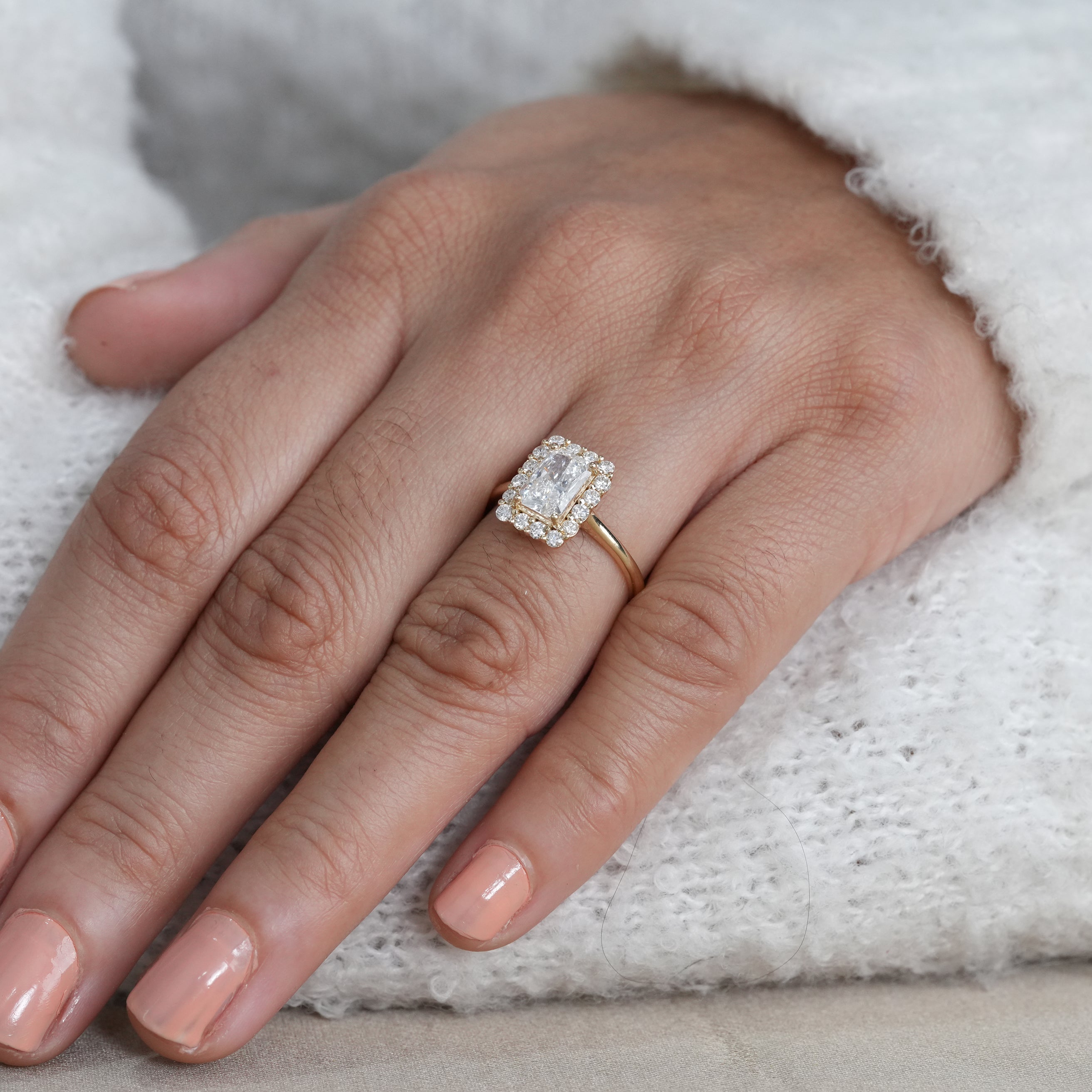 Modern rectangular radiant lab grown diamond ring with diamond halo setting