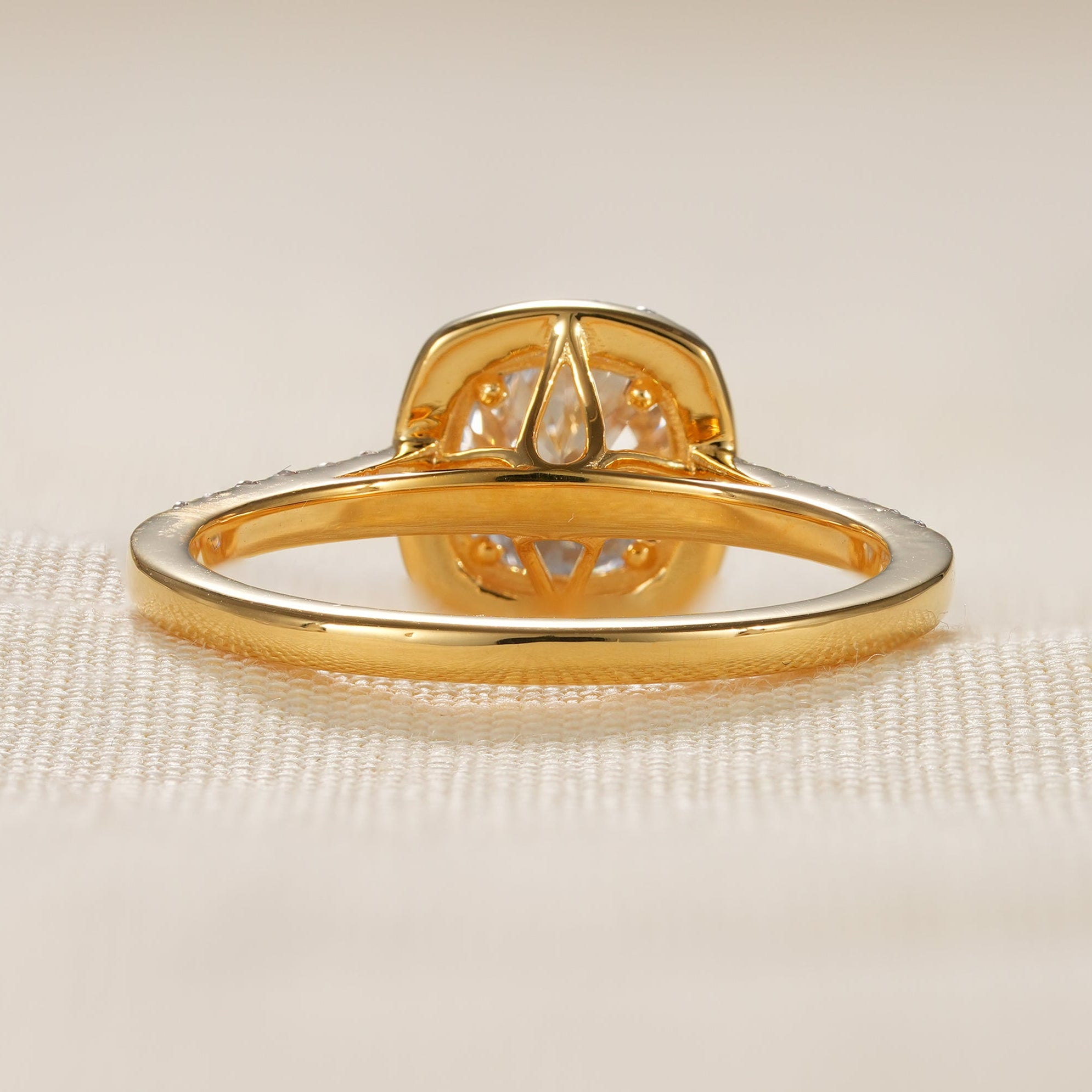 Modern cushion cut solitaire halo ring with shimmering pavé diamonds