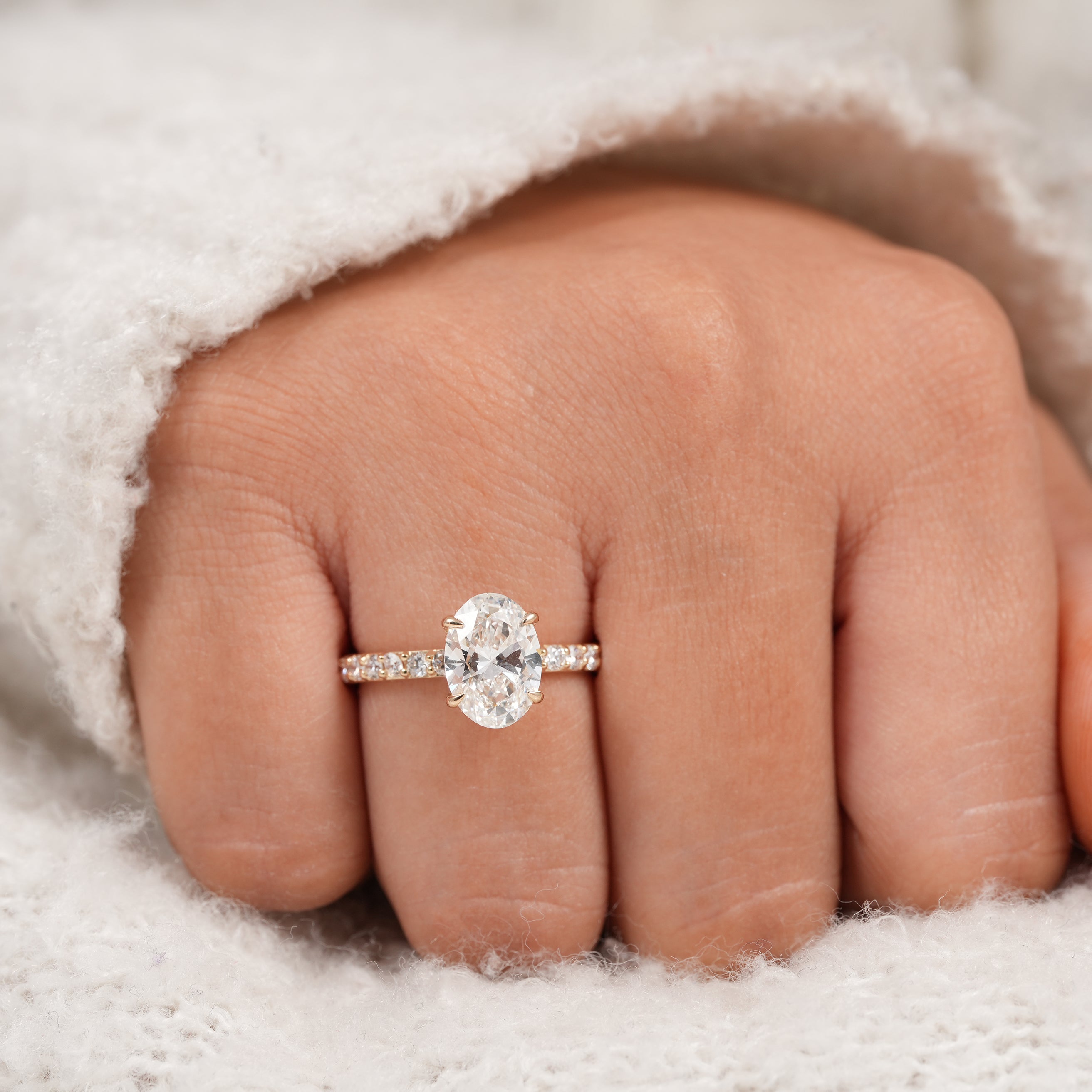 Classic oval cut diamond ring with delicate pavé yellow gold setting