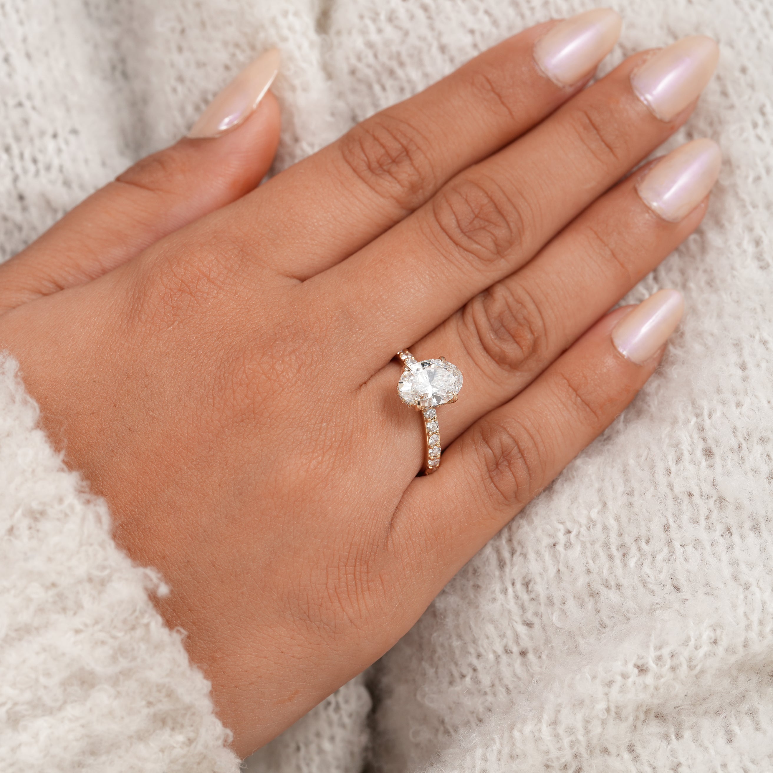 Hidden halo oval engagement ring with sparkling lab grown diamond