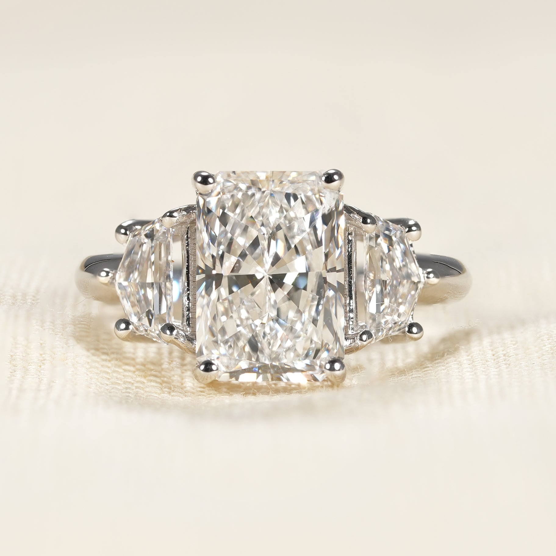 Three stone radiant cut lab diamond engagement ring with Cadillac side stones