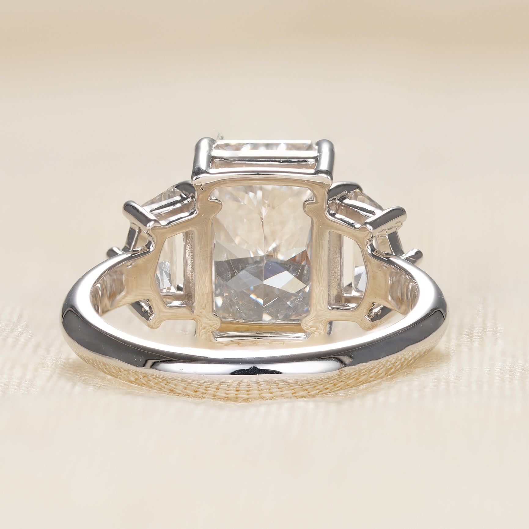 Modern bridal ring featuring radiant center stone and Cadillac side diamond accents