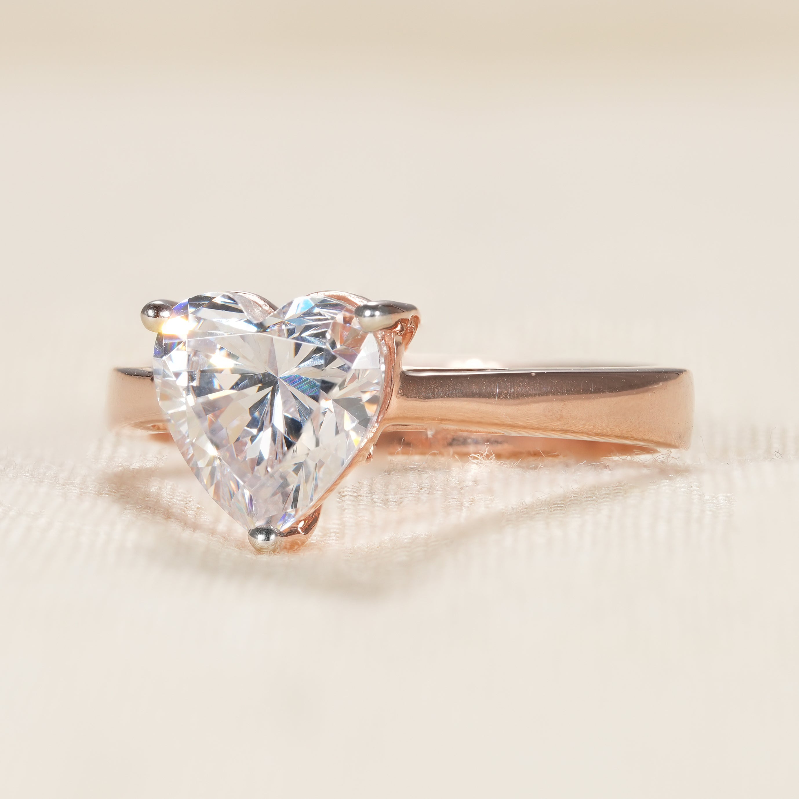 Rose gold heart cut engagement ring with three prong solitaire design