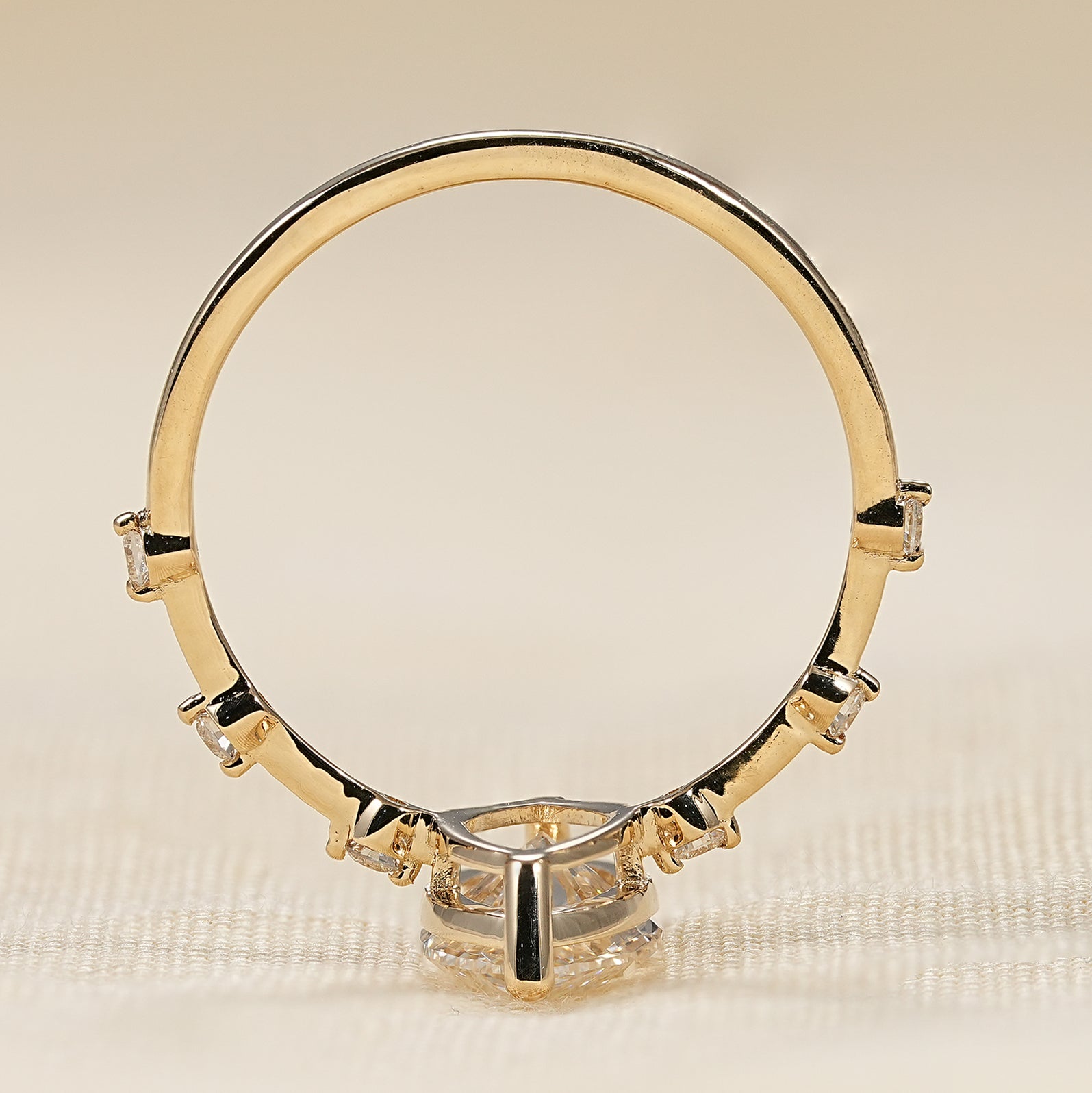 Yellow gold marquise cut engagement ring with dainty round diamond details