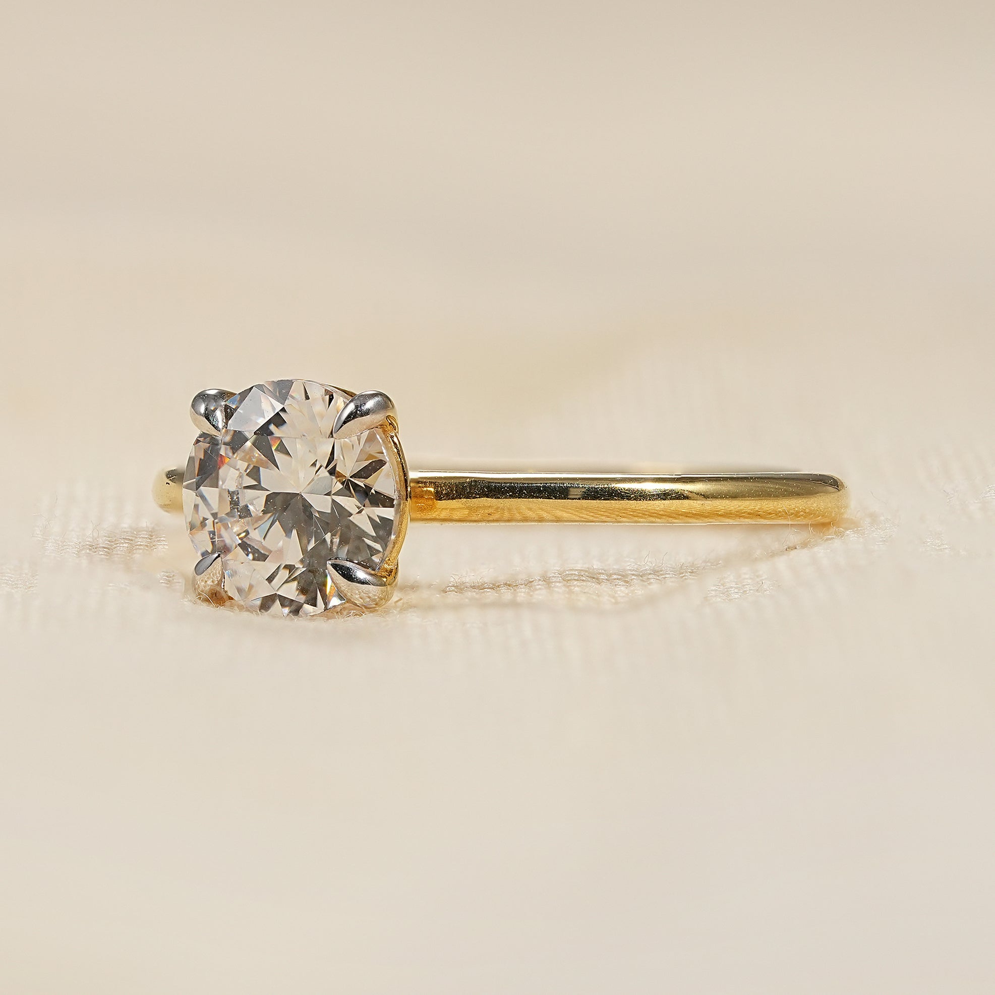 Round cut lab grown diamond ring with delicate yellow gold band
