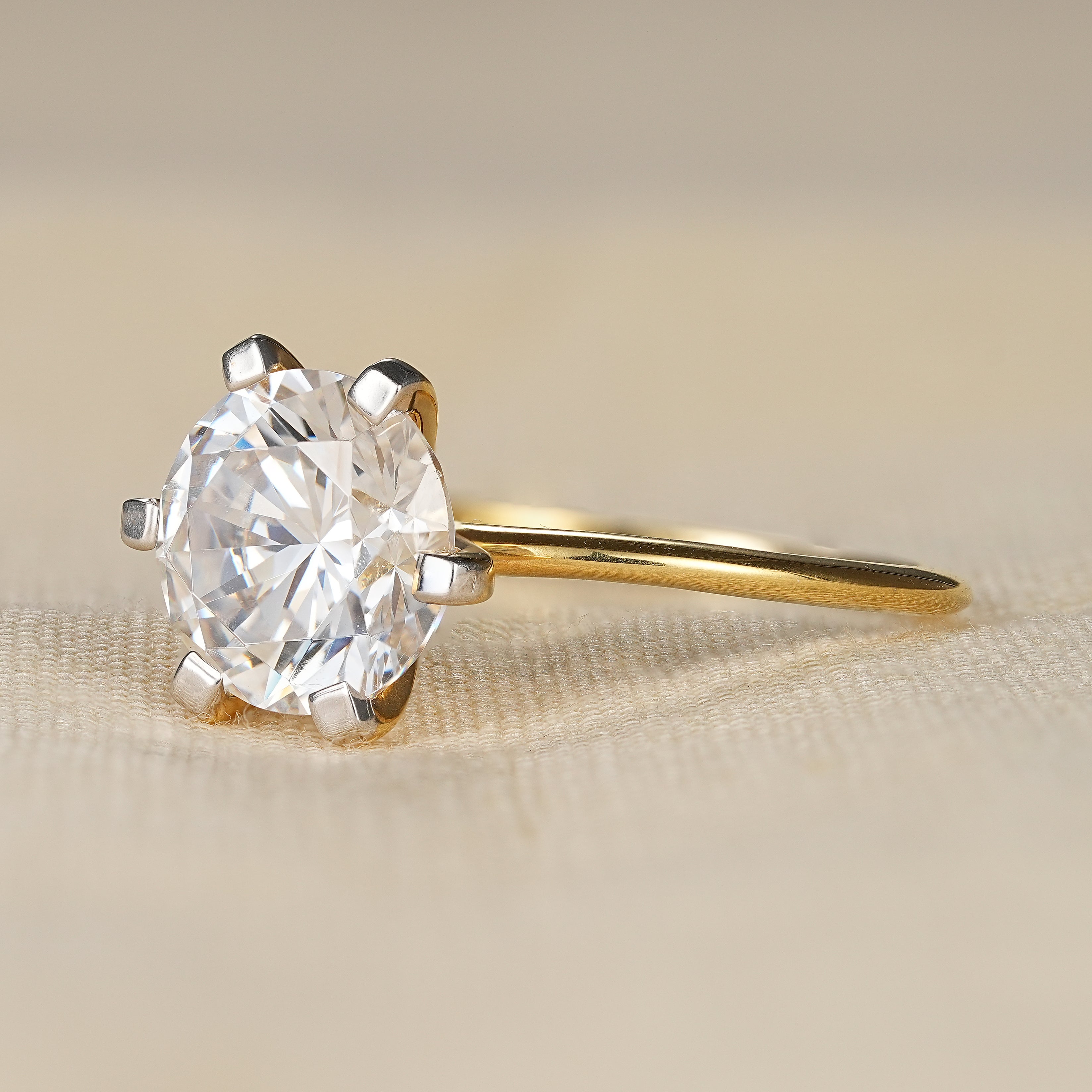 Elegant six prong round solitaire engagement ring with yellow gold band