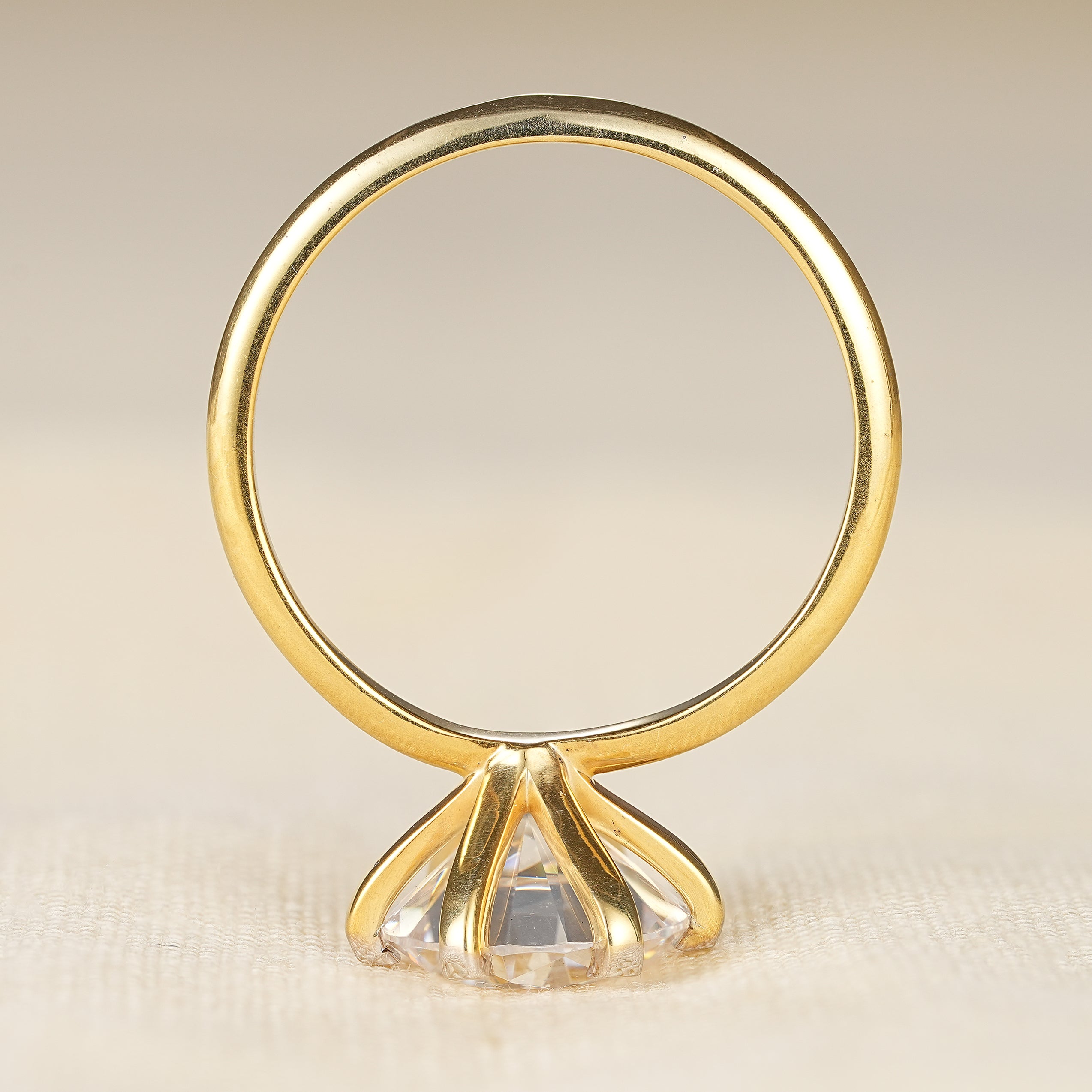 Round cut solitaire engagement ring with sleek yellow gold minimalist band